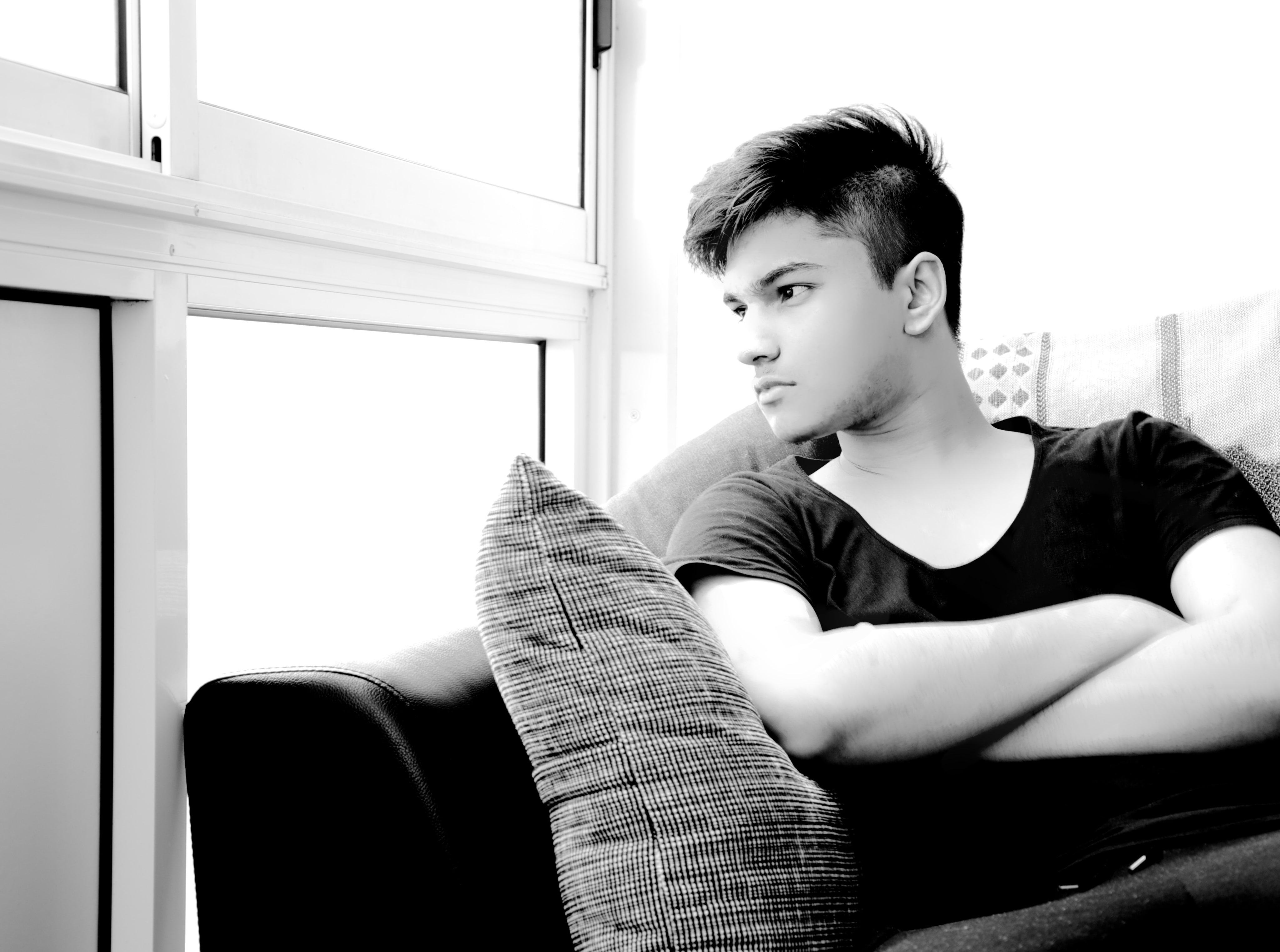 neck, real people, sofa, portrait, Models, sitting, men, Monochrome, indoors, looking, three quarter length, t, shirt, home interior, one person, contemplation, HD Wallpaper