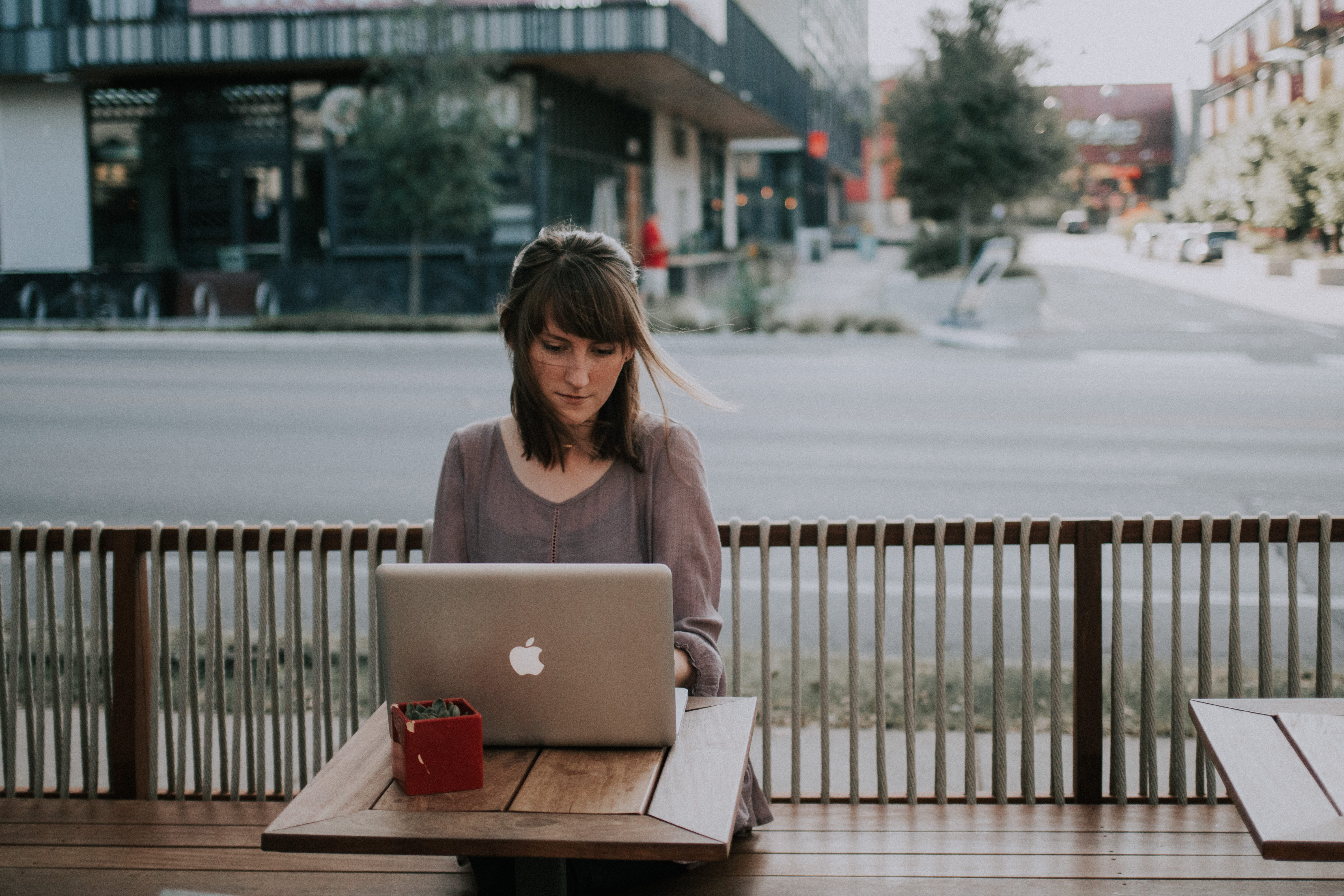 MacBook, adult, seat, people, brown, sitting, front, computer, real people, outdoors, architecture, day, one Person, grey, focus on foreground, internet, HD Wallpaper
