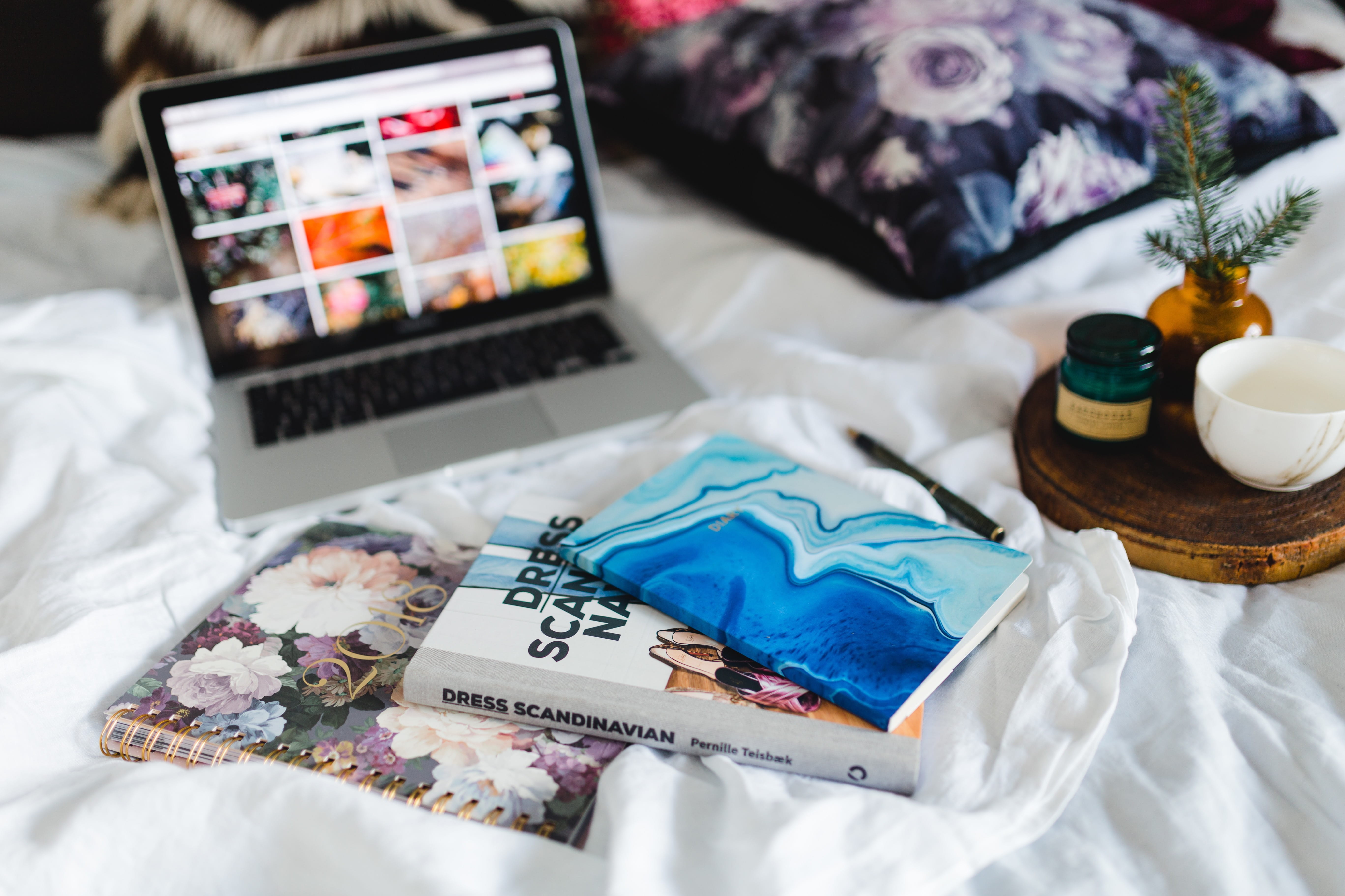 magazines, floral pattern, paper, diary, domestic room, table, relaxation, laptop, pillows, gadgets, bedroom, focus on foreground, computer, no people, HD Wallpaper