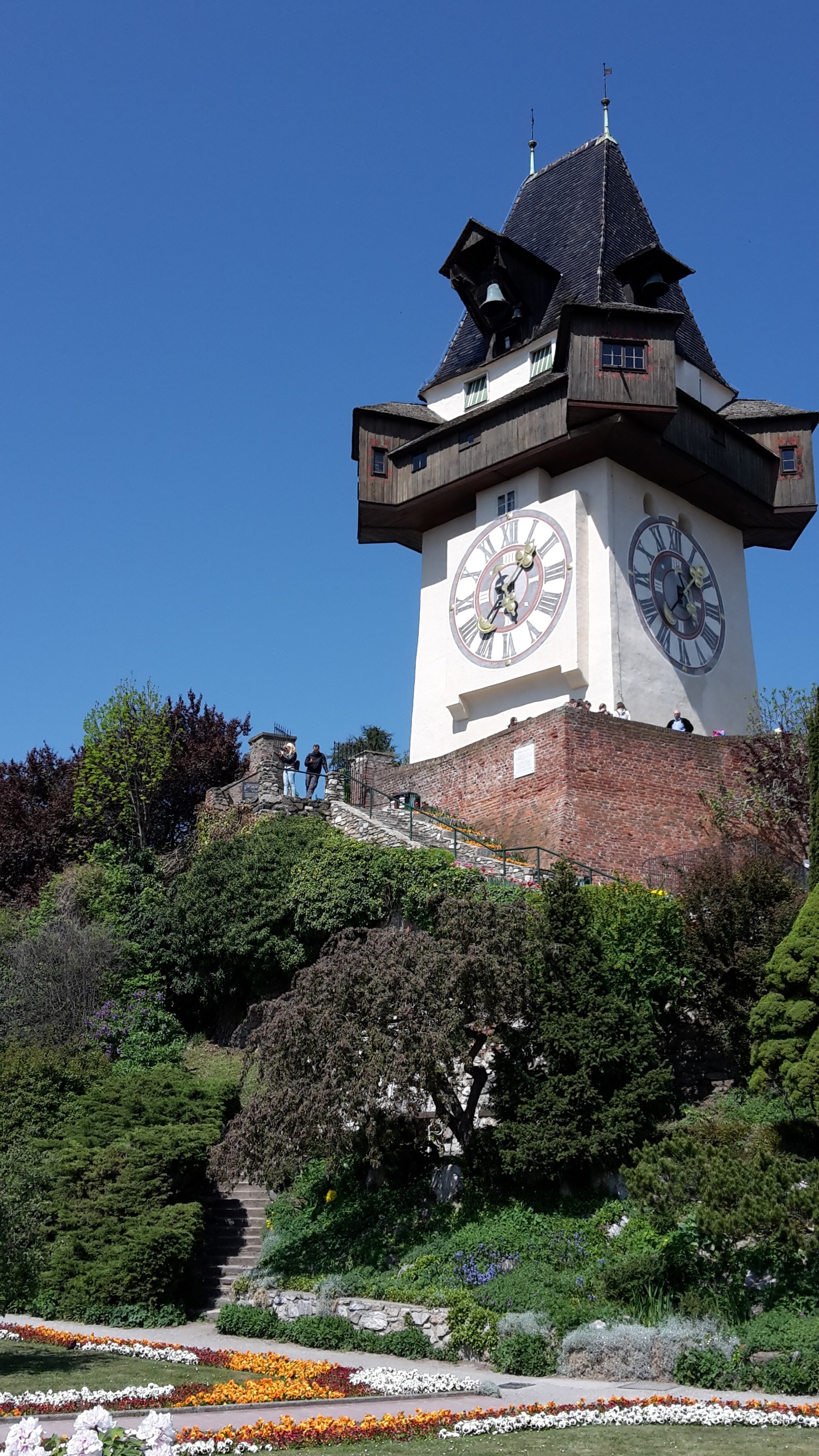 graz, building exterior, built structure, plant, austria, clock, building, sky, tower, tree, religion, place of worship, 2K, low angle view, blue, growth, Phone HD Wallpaper