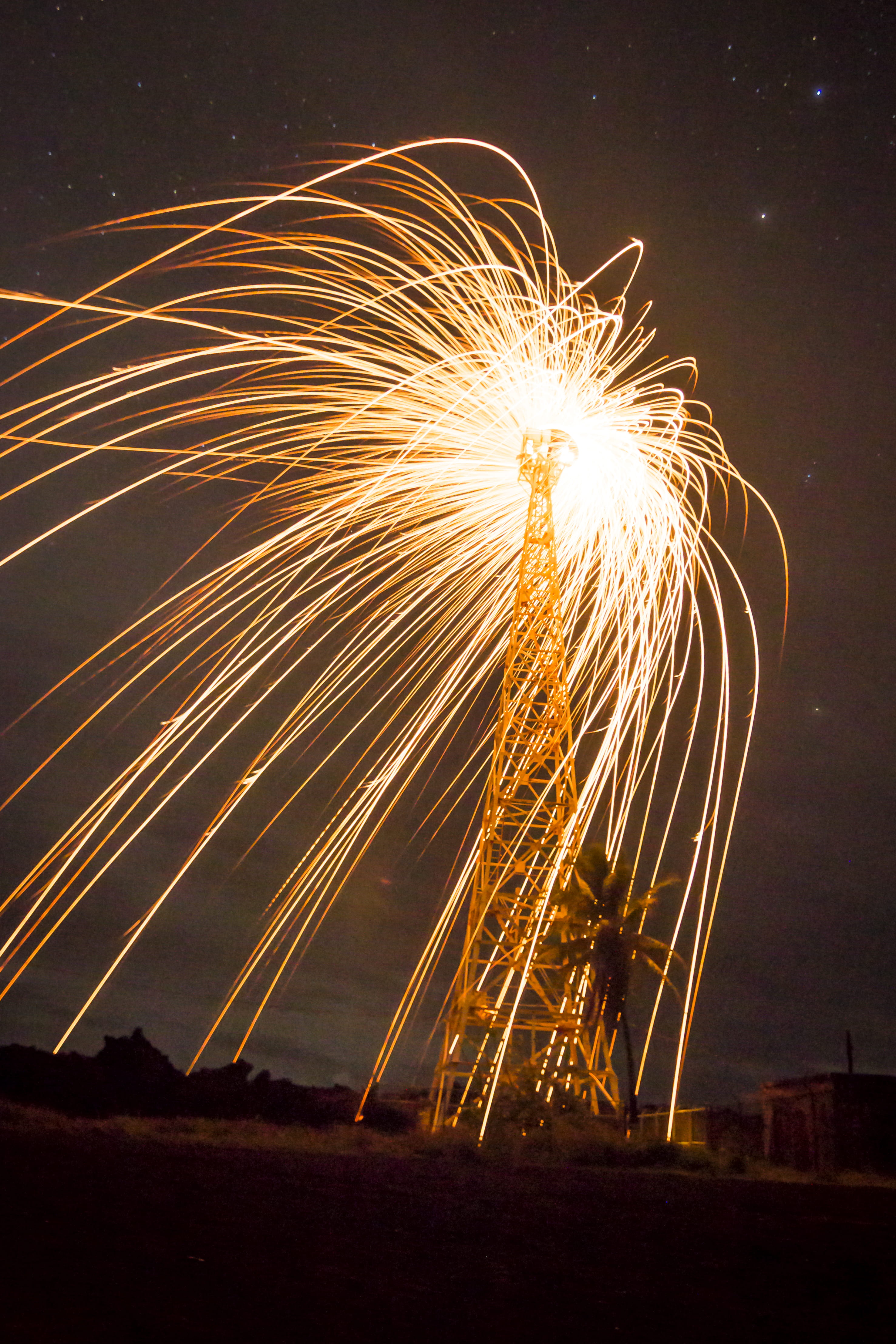fire, sky, blurred motion, land, glowing, night, exploding, nature, hilo, event, burning, no people, celebration, radio tower, height, firework display, Phone HD Wallpaper