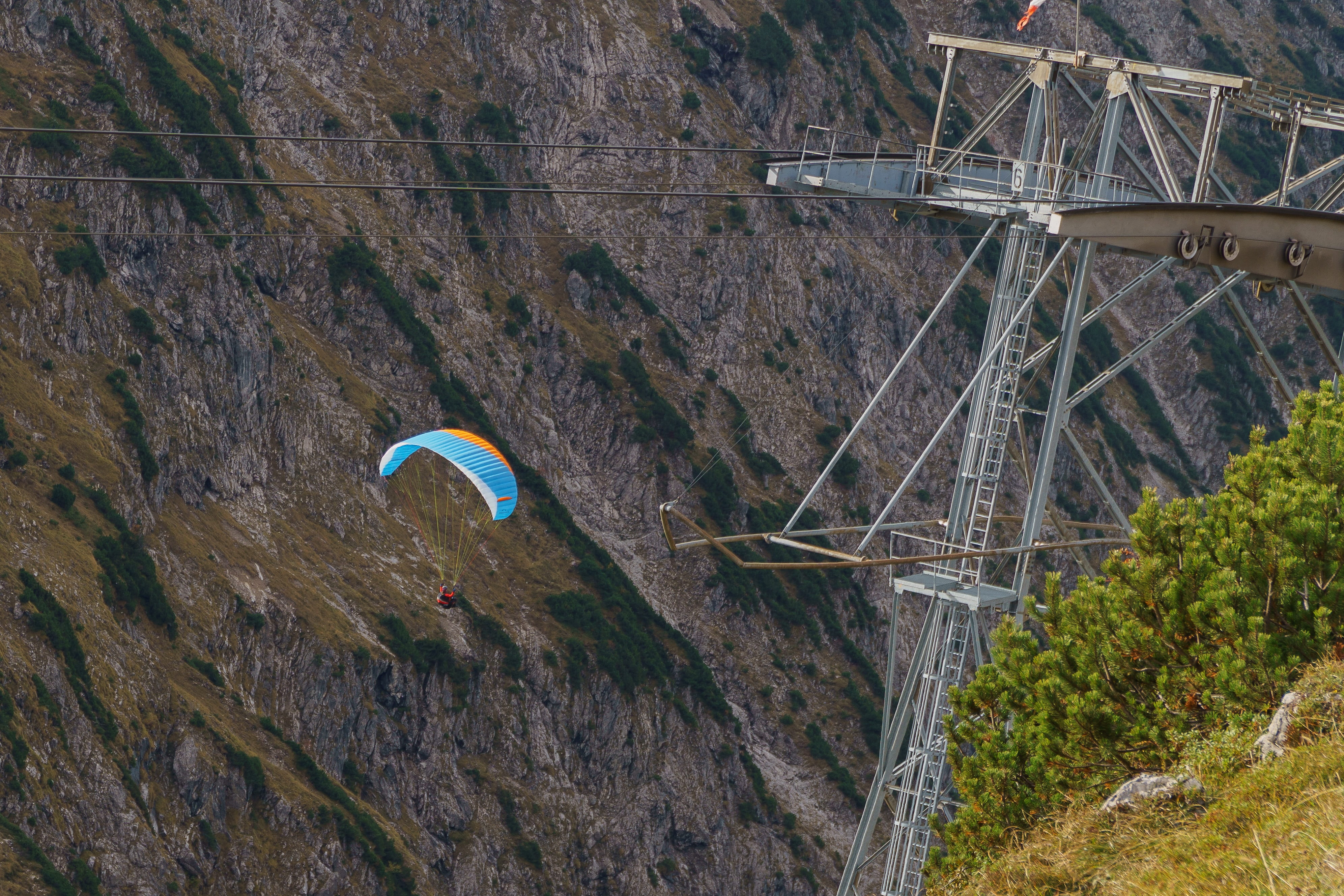 transportation, paragliding, steel, plant, autumn, human, adventure, cable car, day, mid-air, valley, landscape, alpine, non-urban scene, connection, mountains, HD Wallpaper