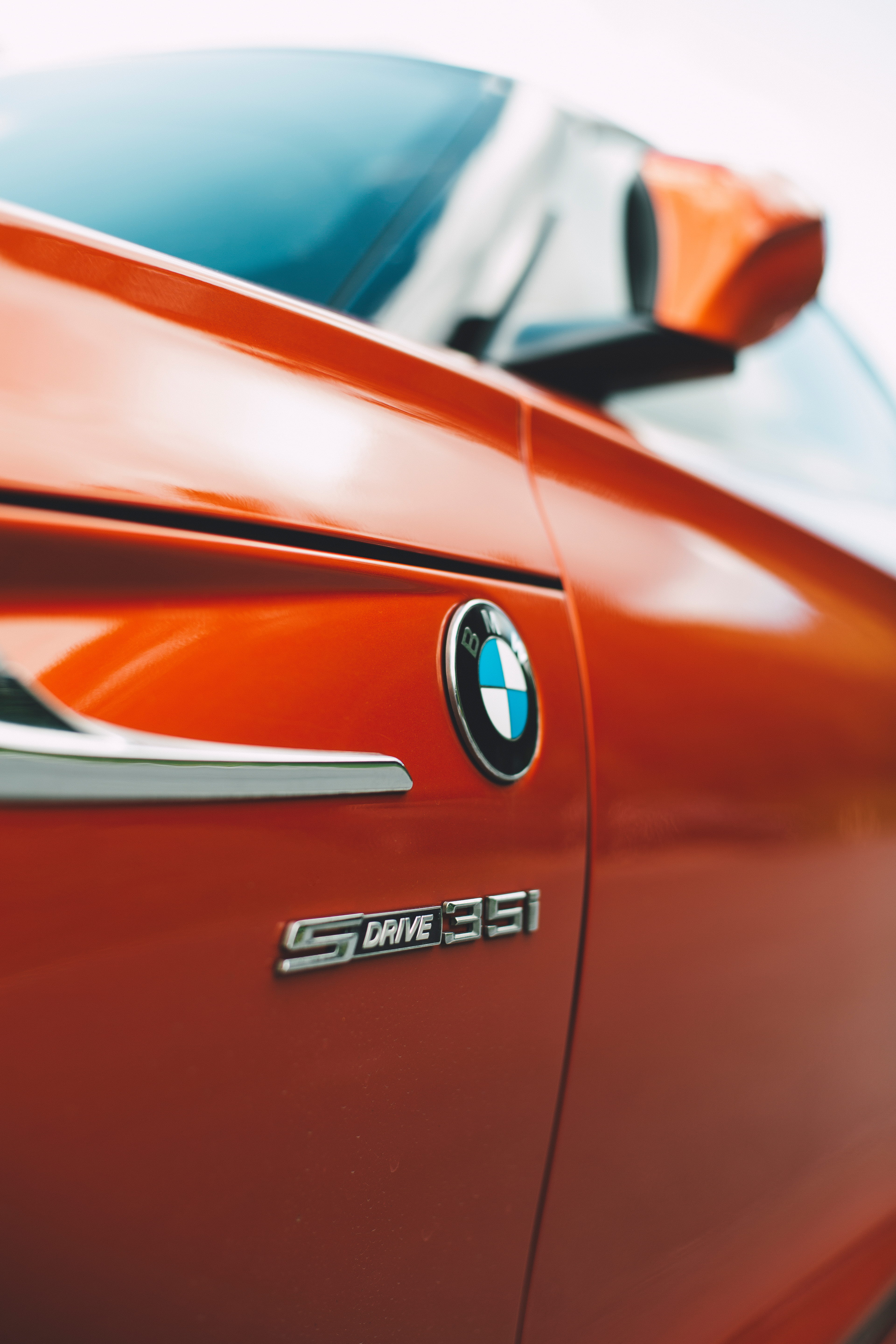 orange color, car, automotive, emblem, reflection, red, chrome, bmw, automobile, coupe, land vehicle, close-up, stationary, transportation, city, lamp, Phone HD Wallpaper