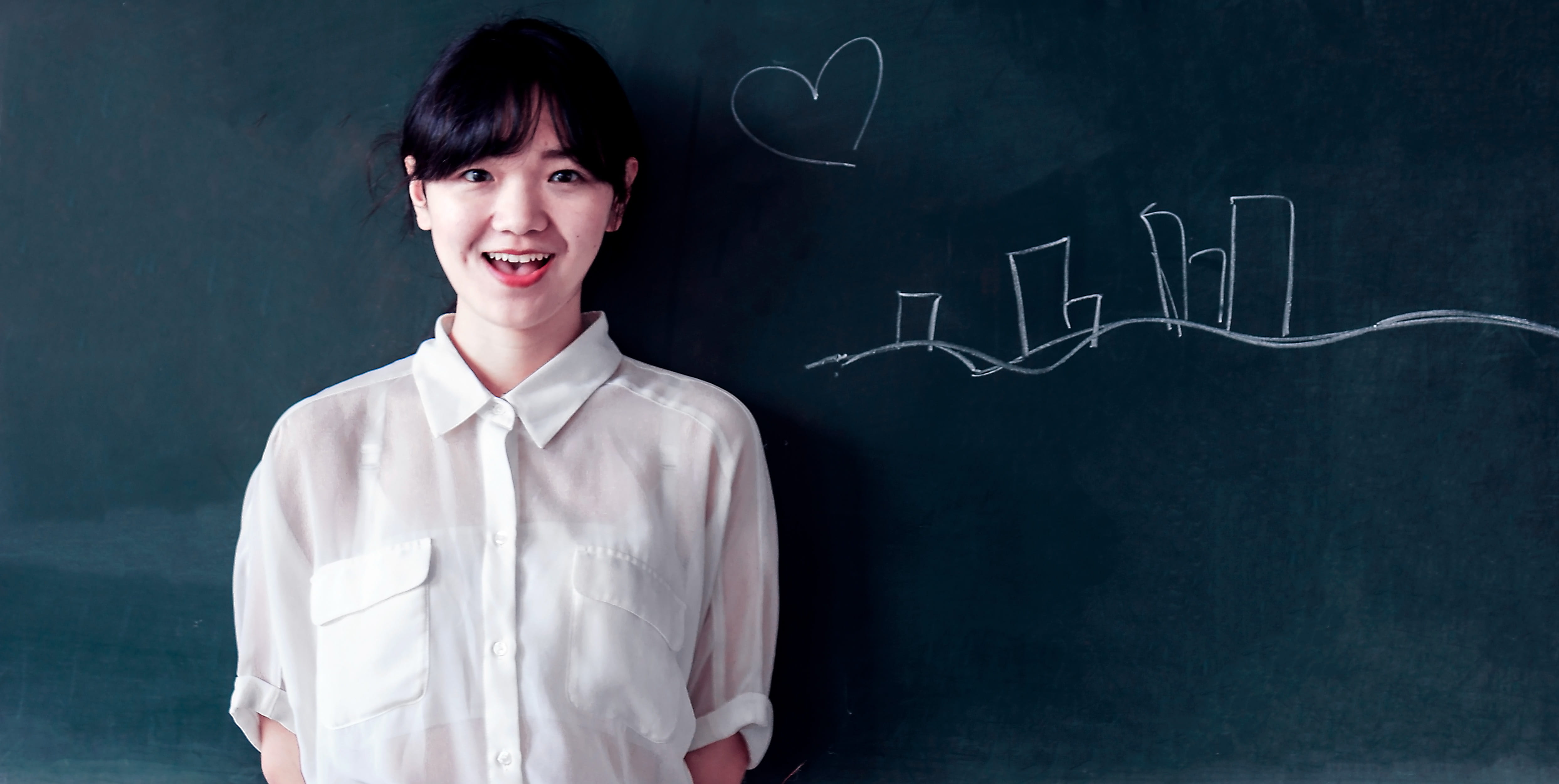pretty, drawing, writing, board, person, toothy smile, studying, 4K, stands, cheerful, front view, learning, looking at camera, wall, chalk, white shirt, HD Wallpaper
