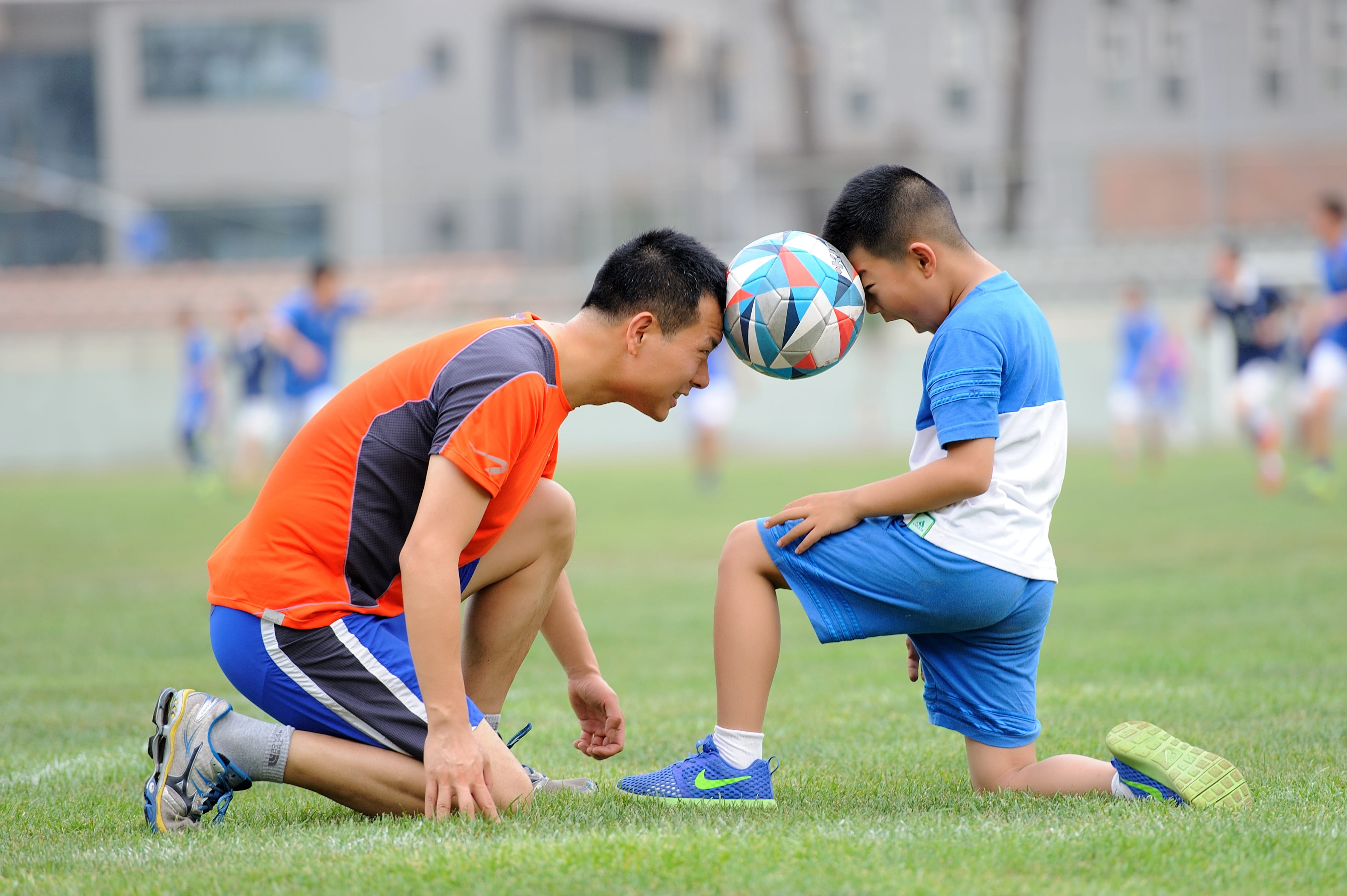 people, exercising, greenery, football, playing, train, day, focus on foreground, childhood, player, soccer, ball, child, playing Field, coach, practicing, HD Wallpaper