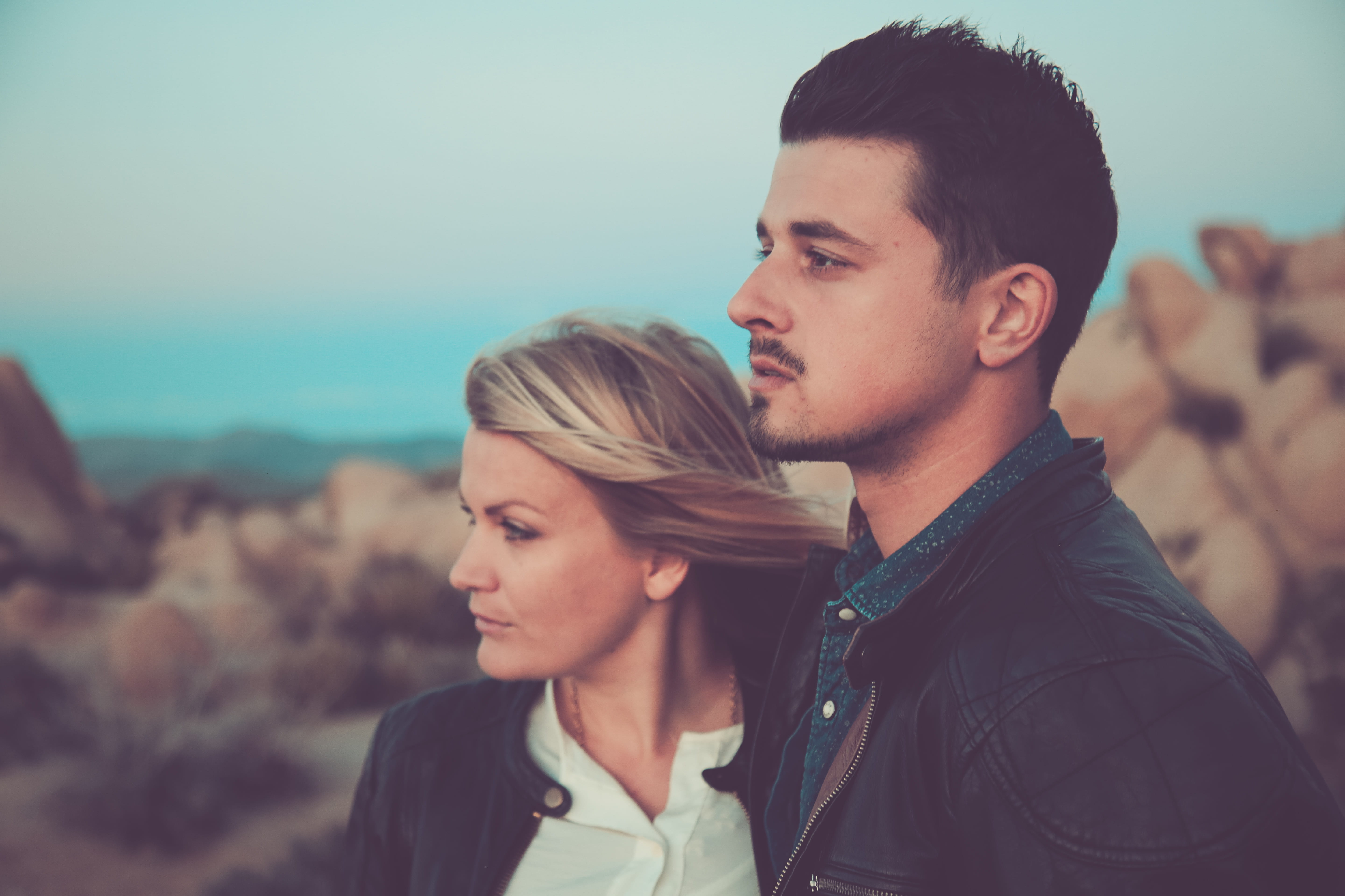 rock, young couple, woman, portrait, seriou, engagement shoot, mountain, leisure activity, women, beautiful woman, side view, 5K, whats over there, focus on foreground, HD Wallpaper