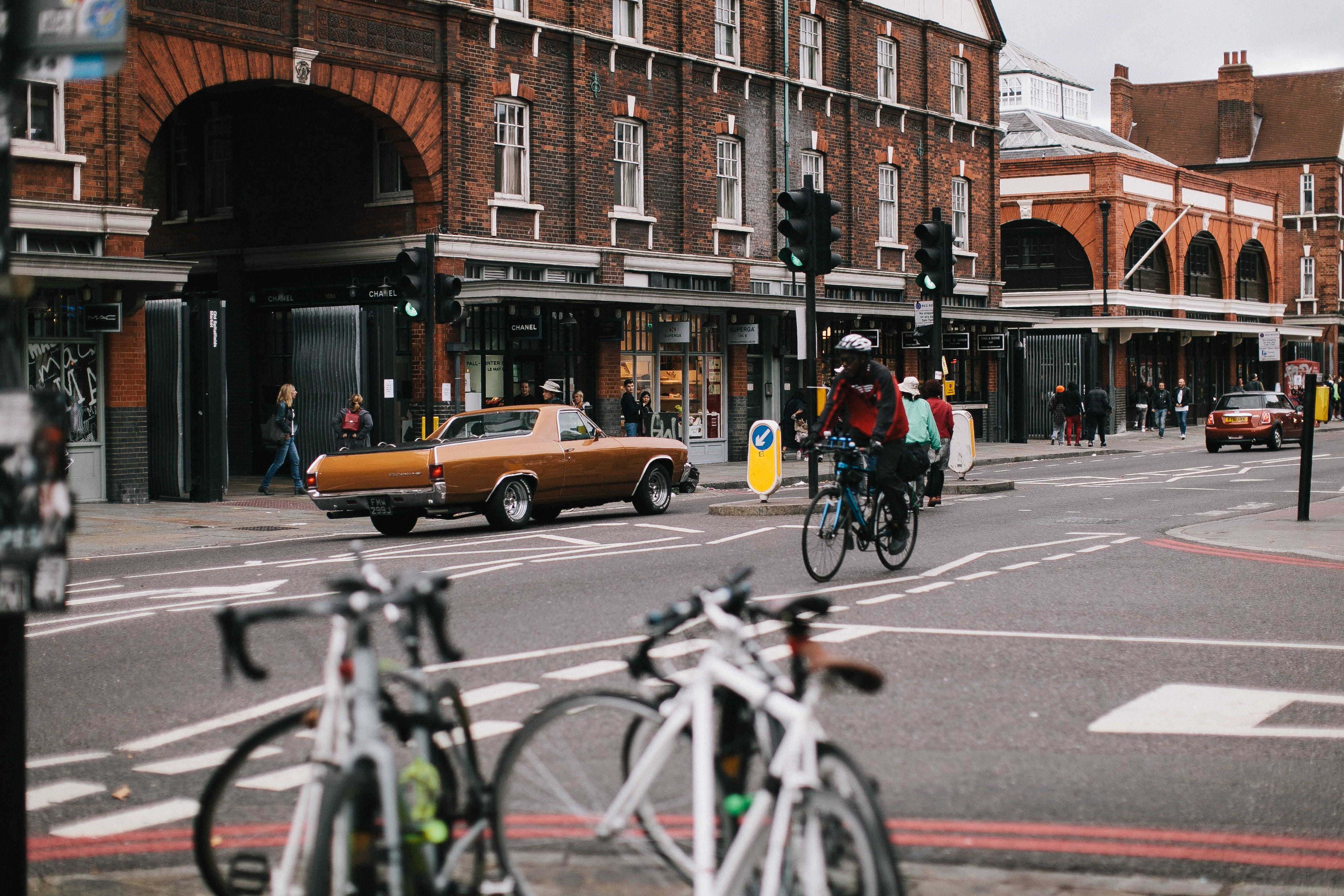 people, travel, architecture, sport, transportation, action, car, daylight, wheels, pavement, brown, motor vehicle, traffic, road marking, buildings, traffic lights, HD Wallpaper