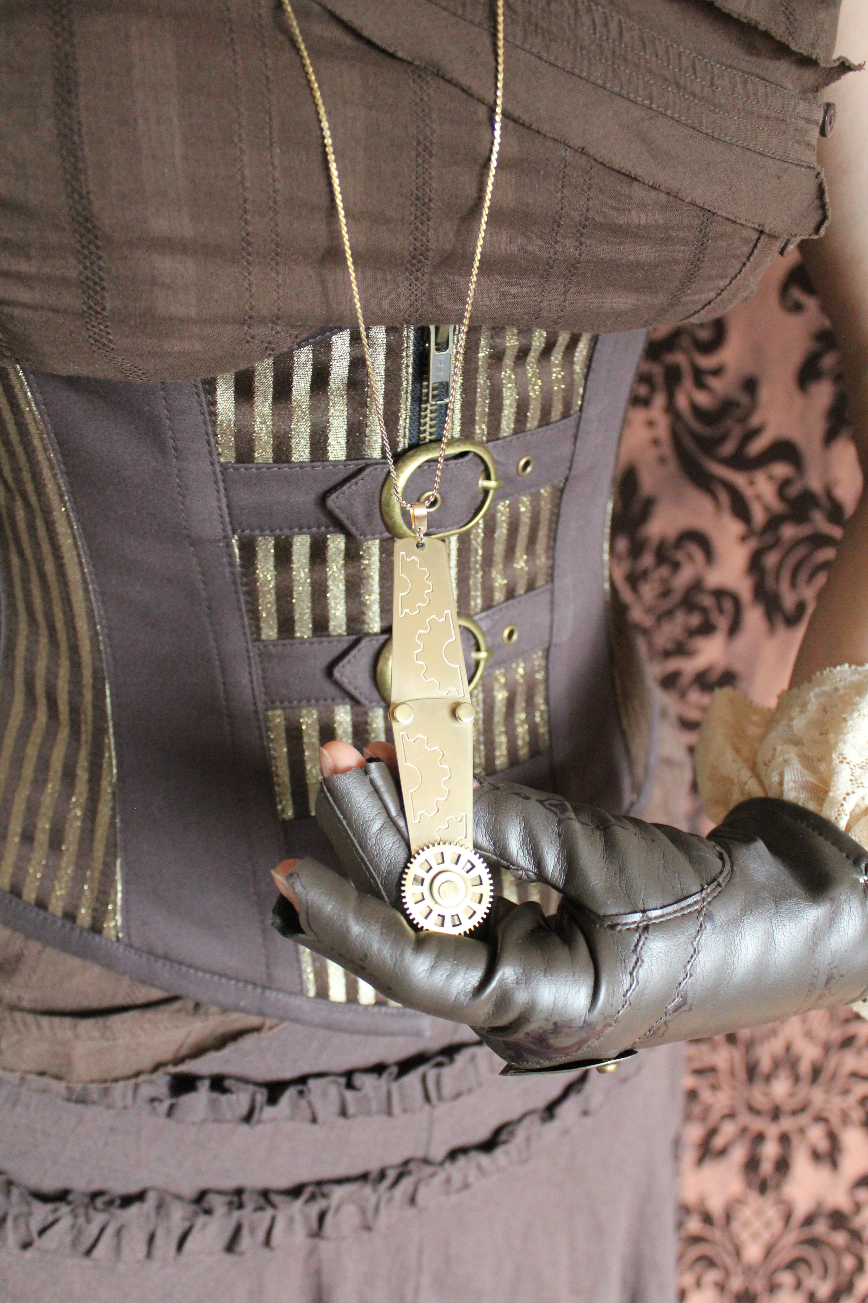 glove, brown, focus on foreground, weapon, necklace, tattoo, corset, cog, lifestyles, steampunk, indoors, human body part, fashion, model, adult, hand, Phone HD Wallpaper