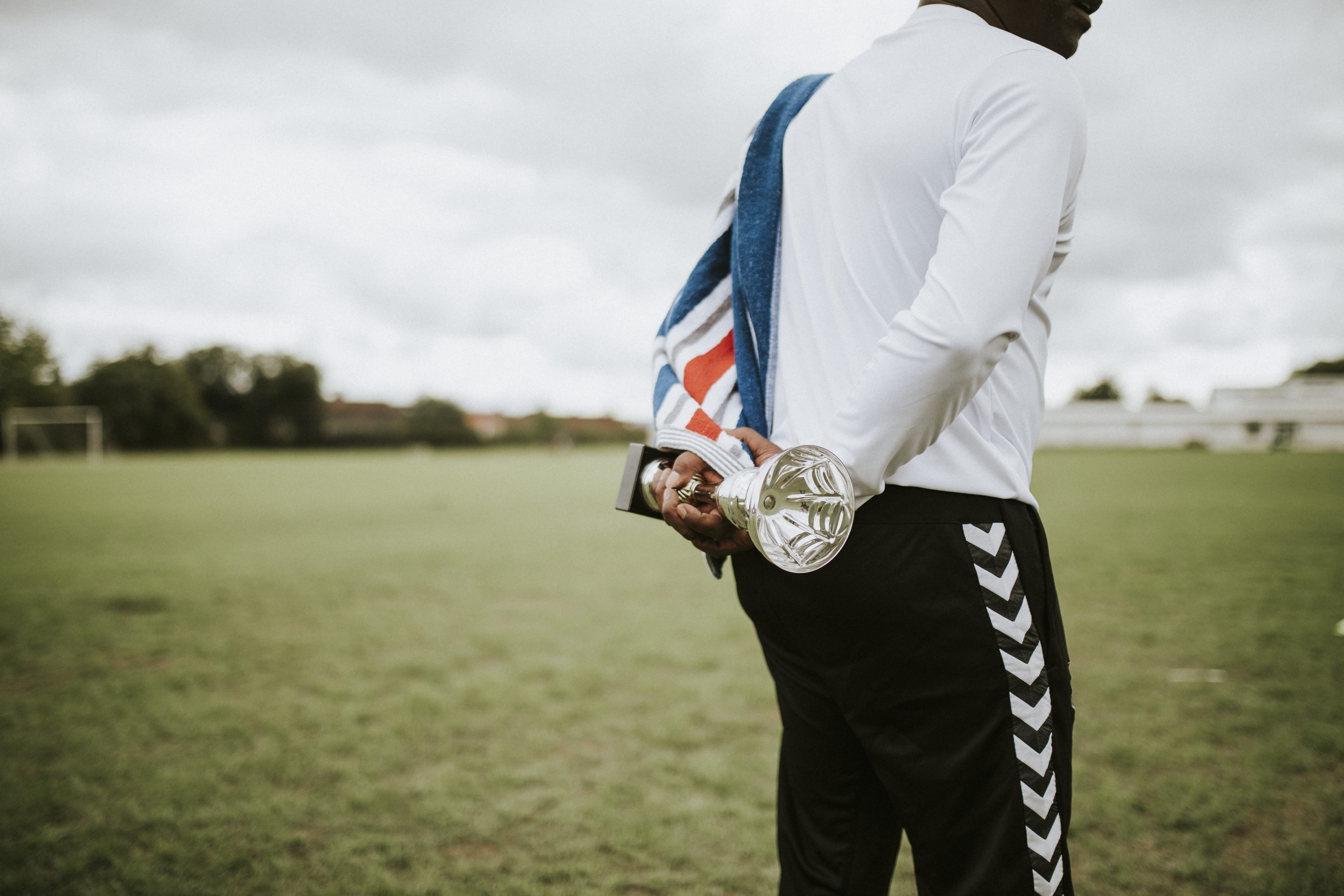 award, casual clothing, land, prize, competitive, midsection, one person, holding, sky, nature, outdoors, sport, grass, lifestyles, cloud - sky, real people, HD Wallpaper