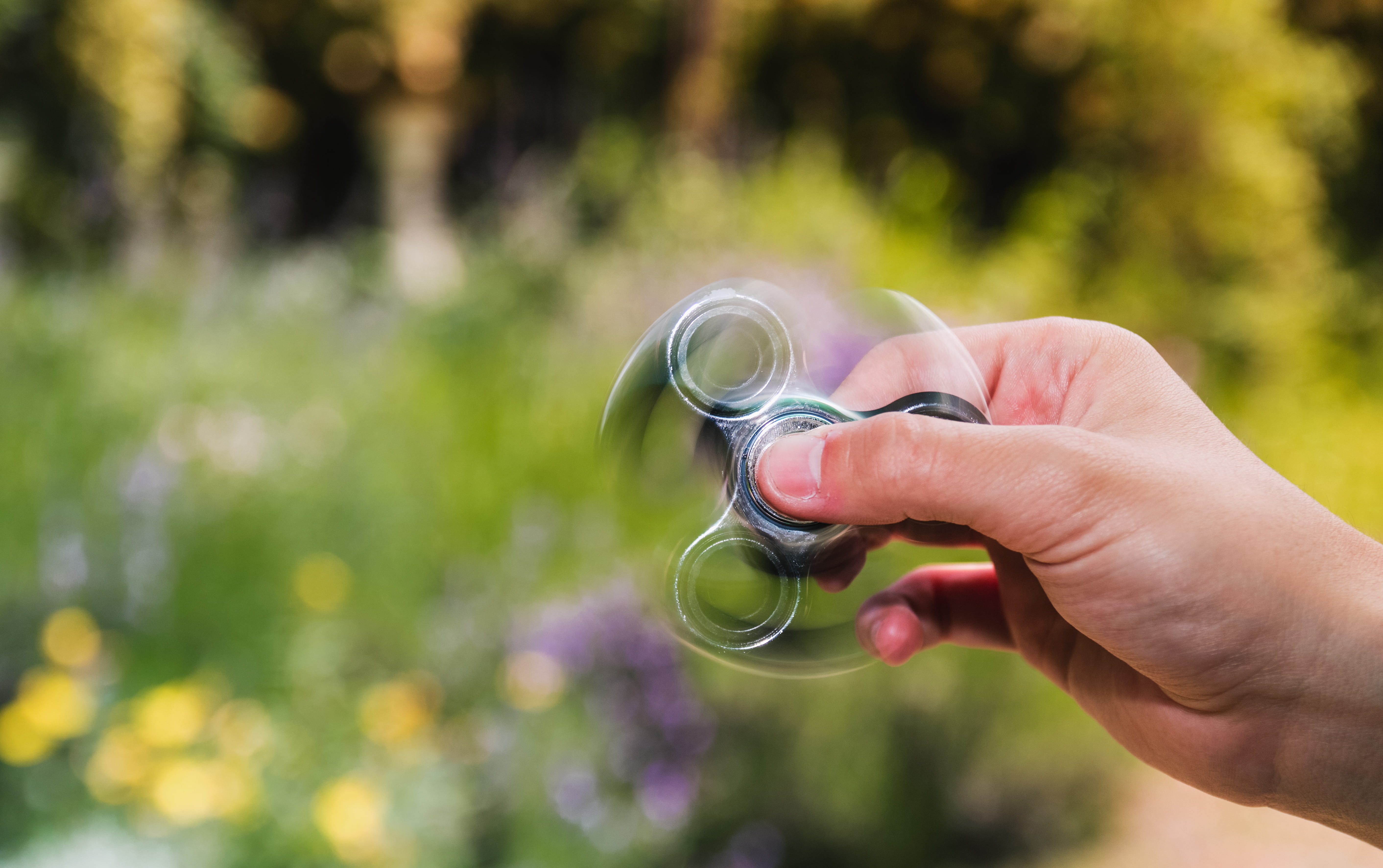 transparent, day, real people, lifestyles, fidget spinner, holding, body part, timelapse, close-up, fidget, human hand, leisure activity, blur, 5K, spinning, HD Wallpaper