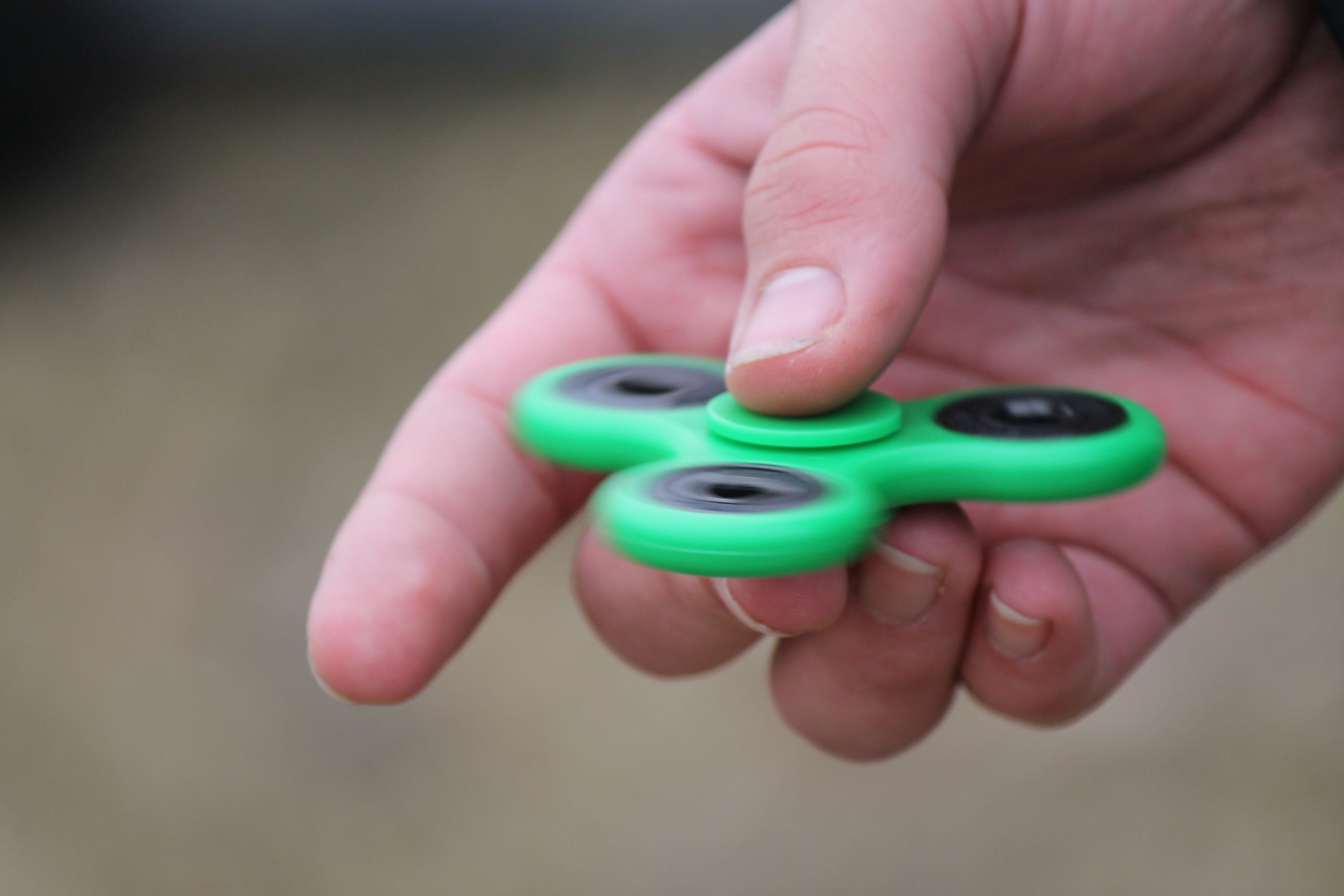 holding, single object, finger, hand, outdoors, childhood, green color, human finger, toy, spin, body part, studio shot, human hand, care, mental health, HD Wallpaper