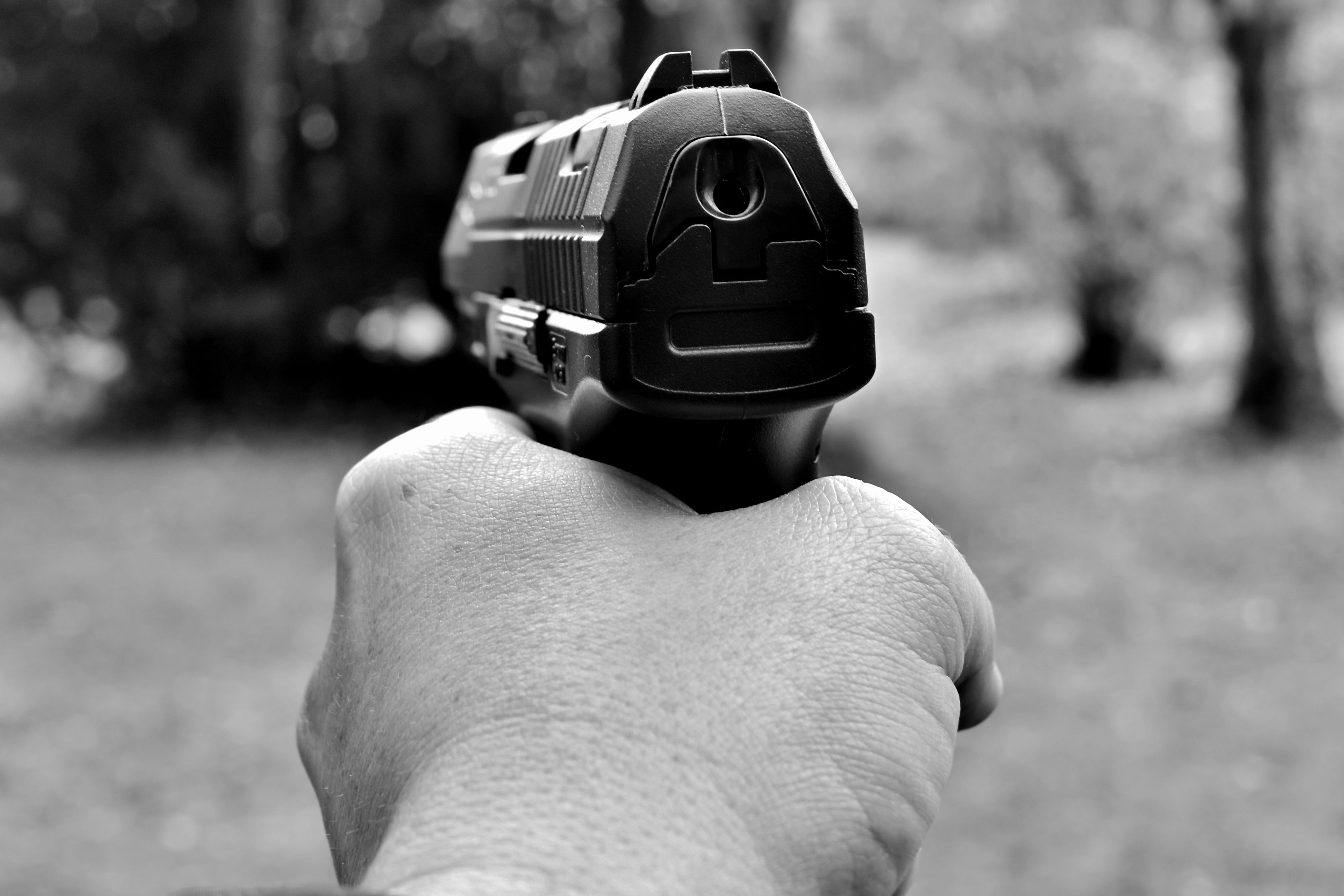 grayscale, defense, focus on foreground, day, finger, lifestyles, fire weapon, outdoors, gun, human body part, security, protect, police, personal perspective, HD Wallpaper