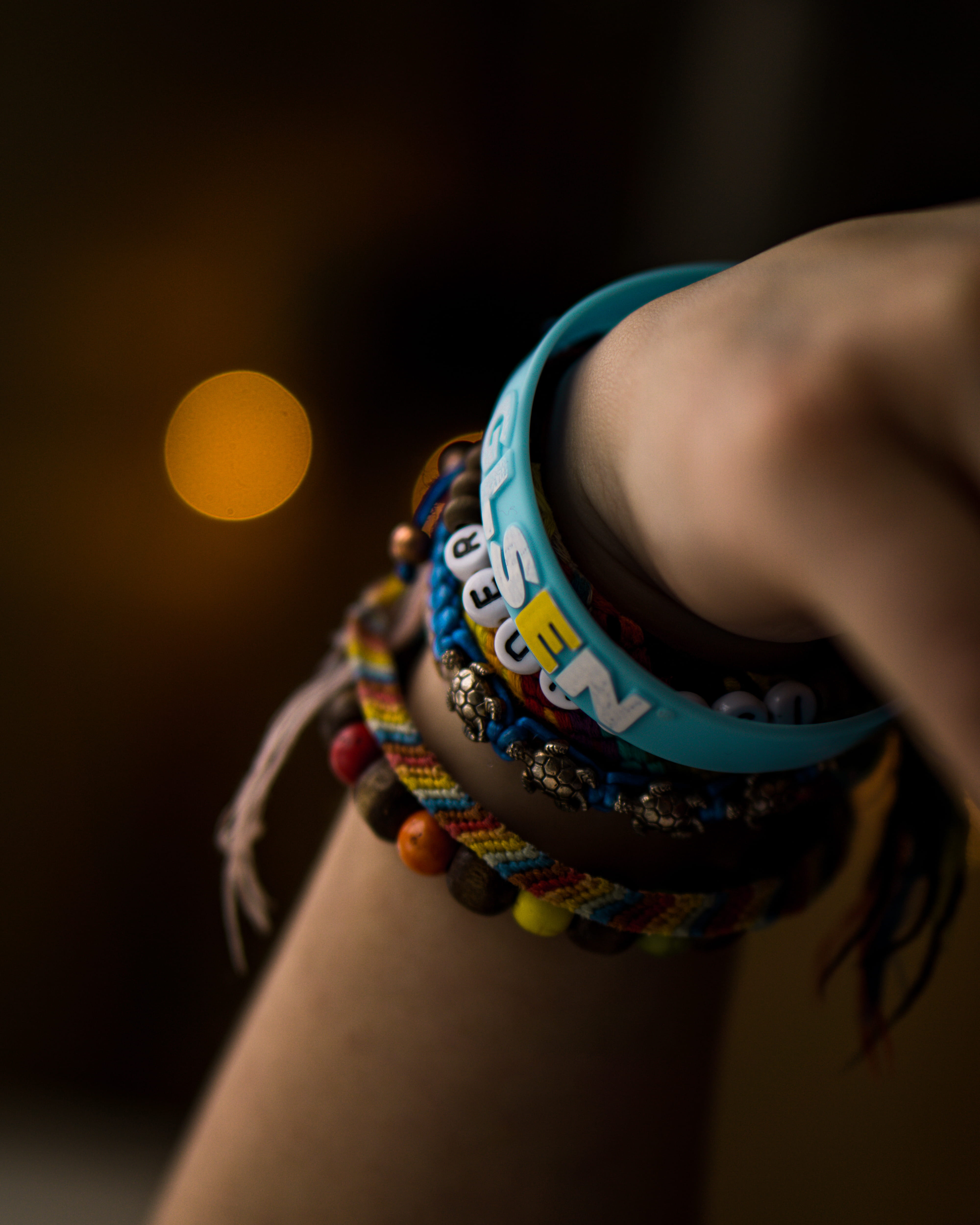 finger, wearing, focus, bracelet, person, colourful, wear, depth of field, bracelets, midsection, indoors, one person, wrist, bangles, hand, text, various, Phone HD Wallpaper