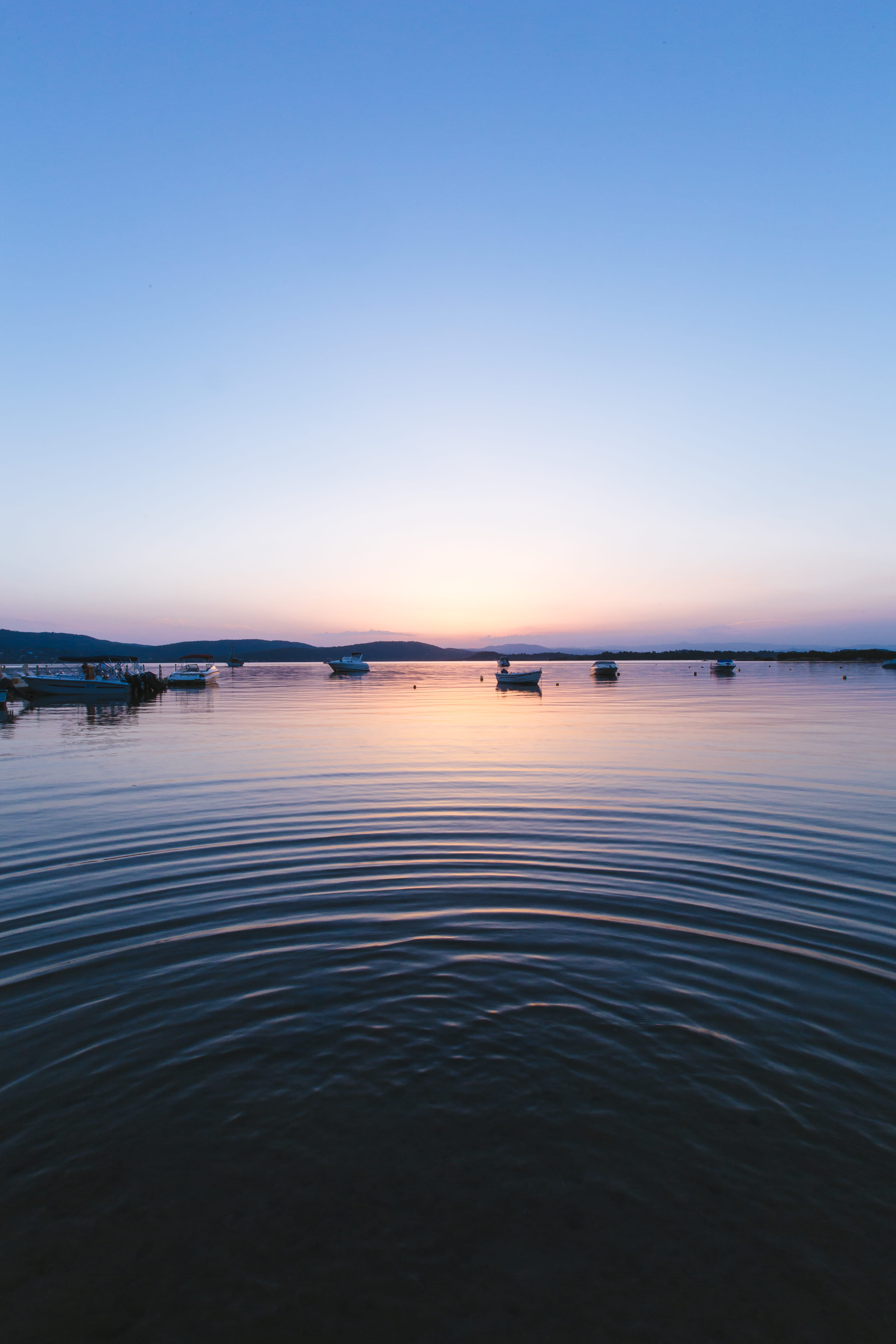 sun, 5K, shadow, boats, beauty in nature, no people, water, tranquility, tranquil scene, dusk, blue, light, halkidiki, reflection, outdoors, boat, nature, Phone HD Wallpaper