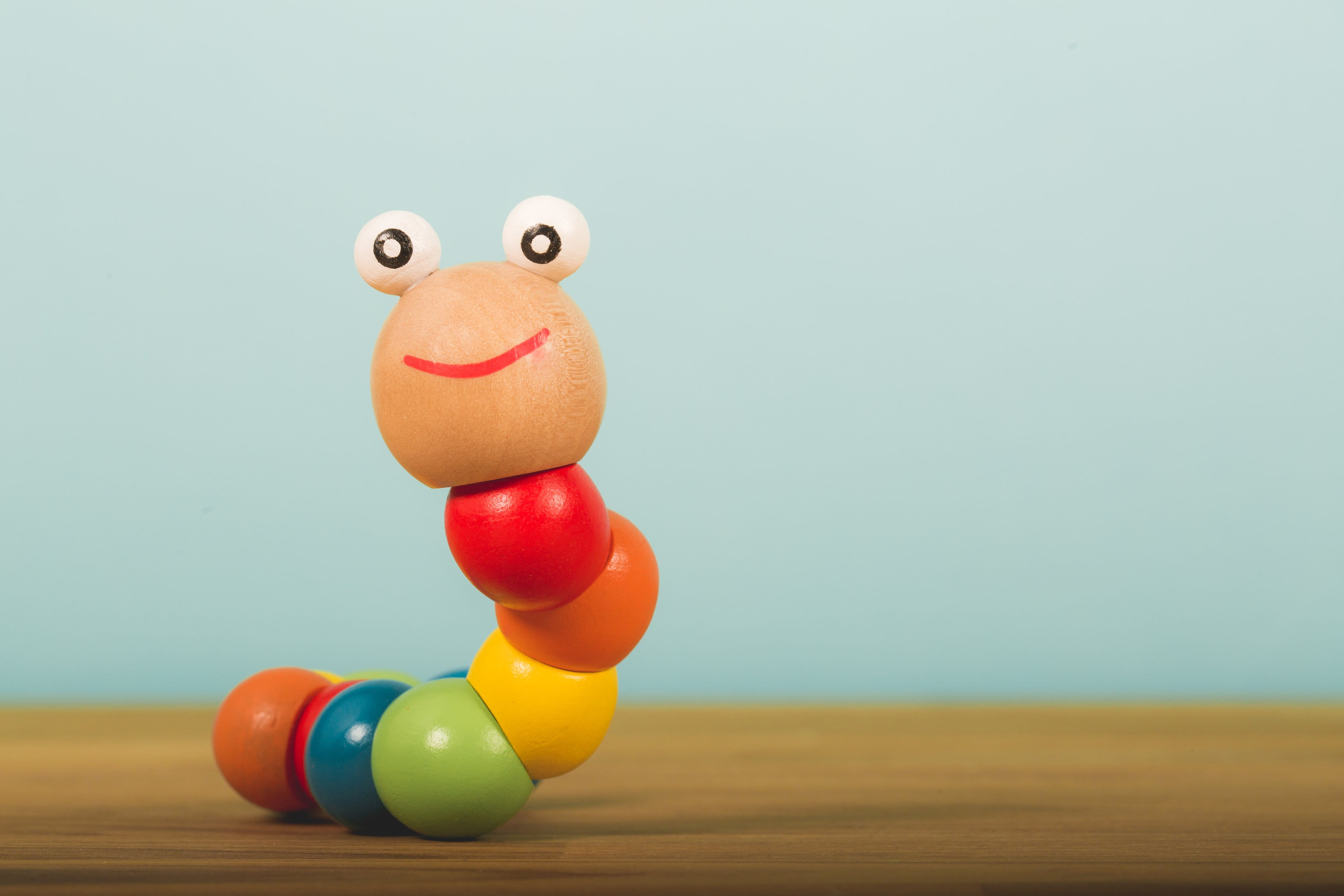 Toys, copy space, wooden, smiling, animal, baby, creativity, anthropomorphic smiley face, blue, yellow, toy, 4K, indoors, studio shot, Smile, worm, single object, HD Wallpaper