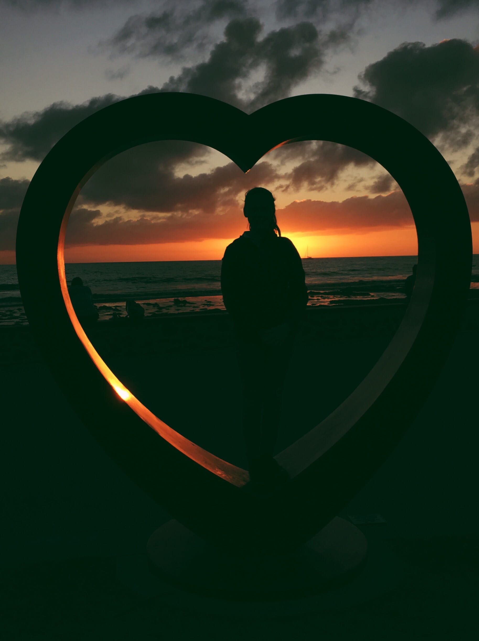 silhouette, sunset, photo, one person, heart, facing, beauty in nature, woman, shape, standing, men, water, cloud - sky, standee, lifestyles, beside, love, Phone HD Wallpaper