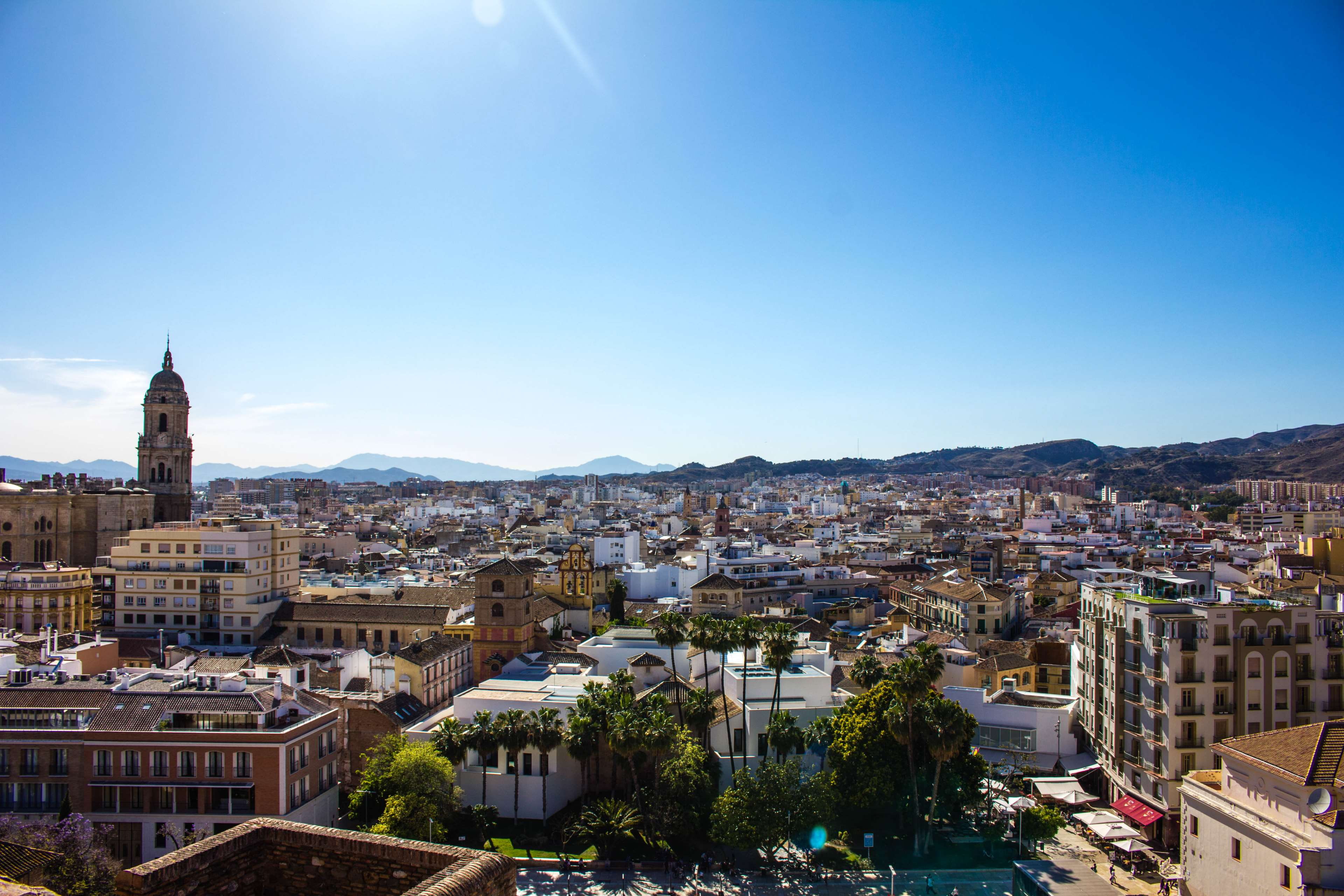 city, building exterior, outdoors, spain, crowded, sunlight, sun, building, malaga, travel destinations, day, crowd, mountain, clear sky, travel, nature, HD Wallpaper