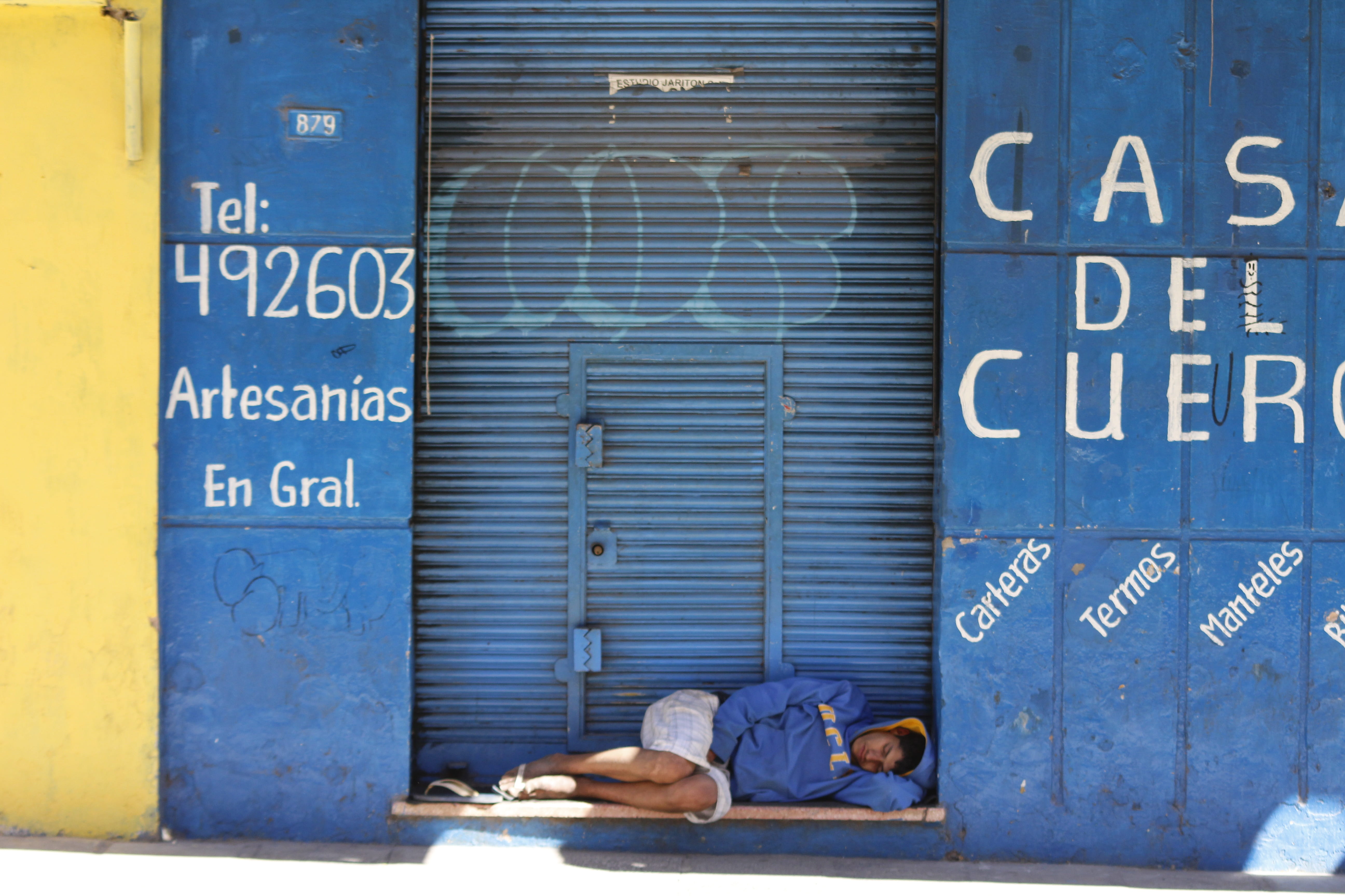 day, shutter, blue, sleeping, text, lying down, architecture, sign, 5K, social issues, real people, western script, one person, full length, communication, HD Wallpaper