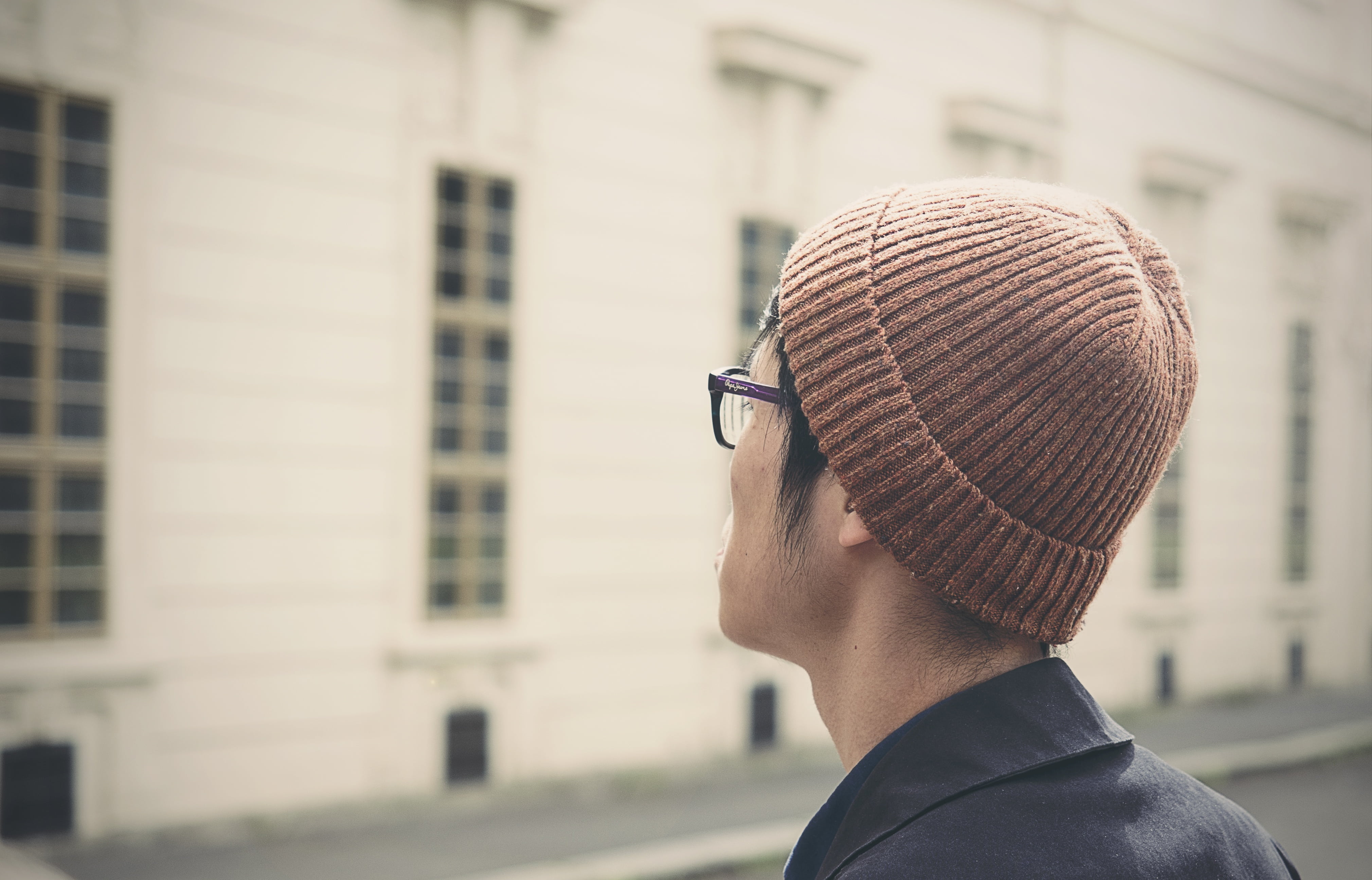 rear view, built structure, sunglasses, blur, one person, close-up, 4K, eyeglasses, building, hat, young adult, person, blurry, boy, beanie, cap, city, HD Wallpaper