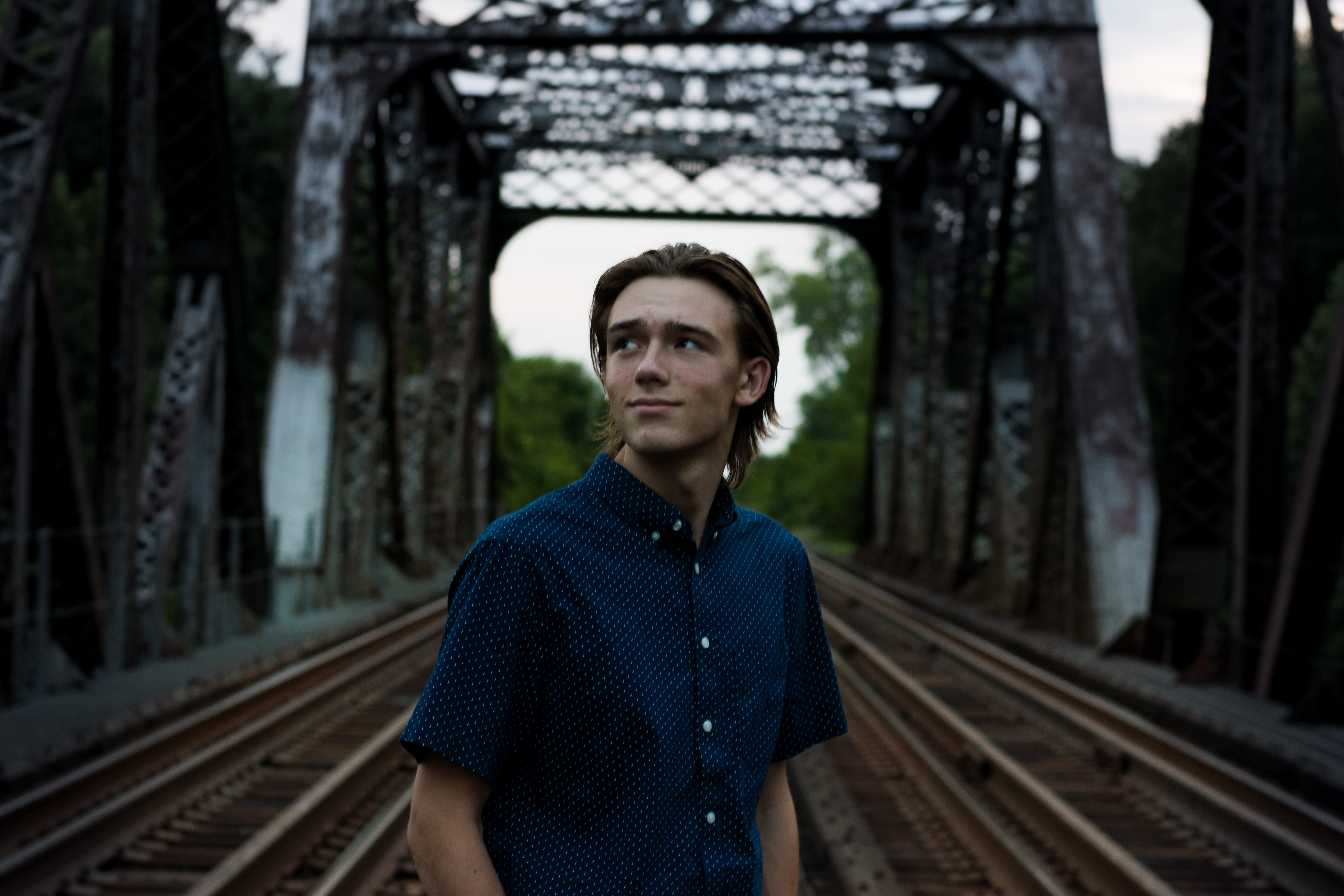 one person, middle, railroad track, male, person, tree, man, adult, hot, day, bridge, structure, transportation, front view, rustic, waiting, real people, HD Wallpaper