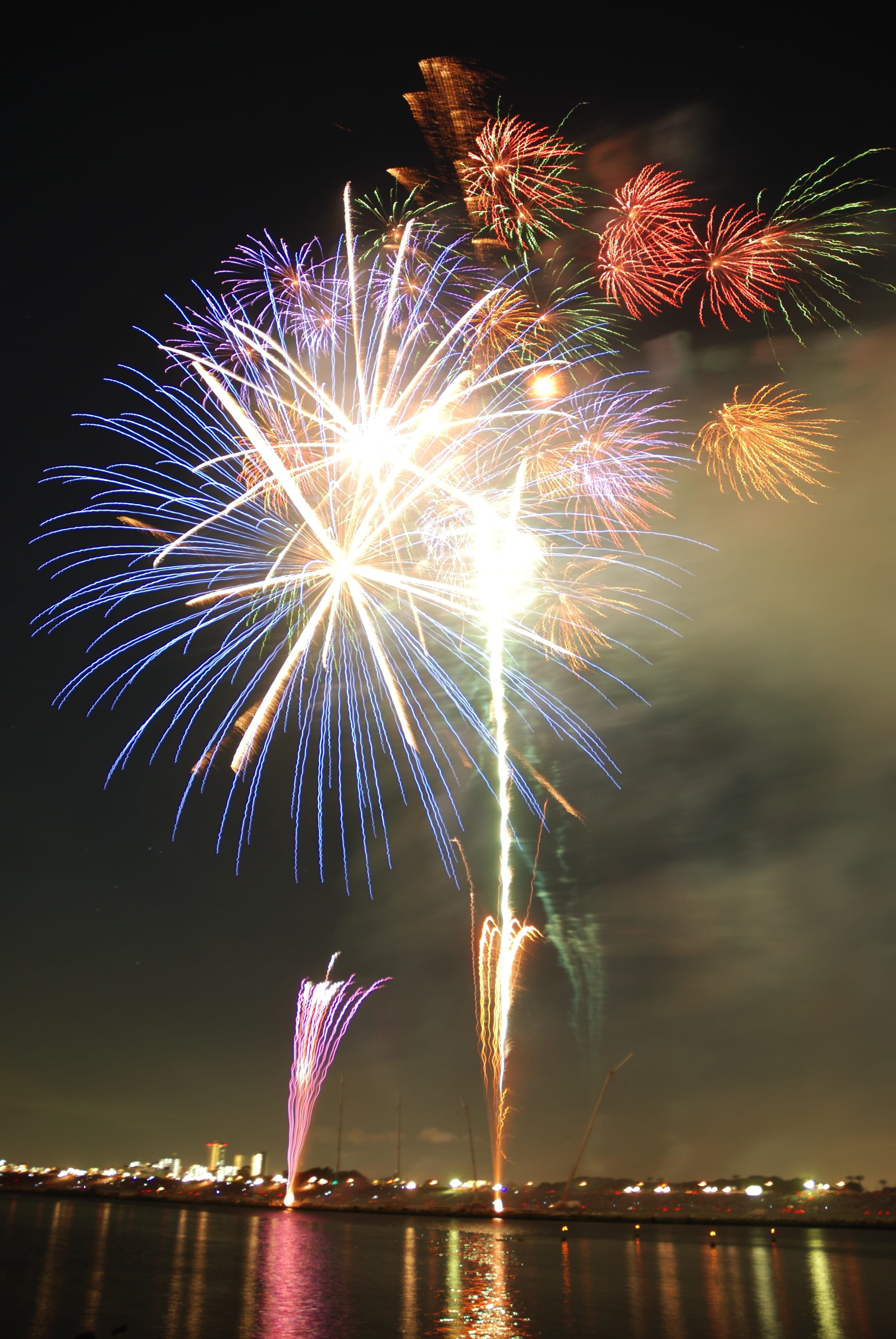 purple, red, water, glowing, reflection, Colorful, night, event, blurred motion, multicoloured, Hanabi, light, green, firework - man made object, exploding, Phone HD Wallpaper