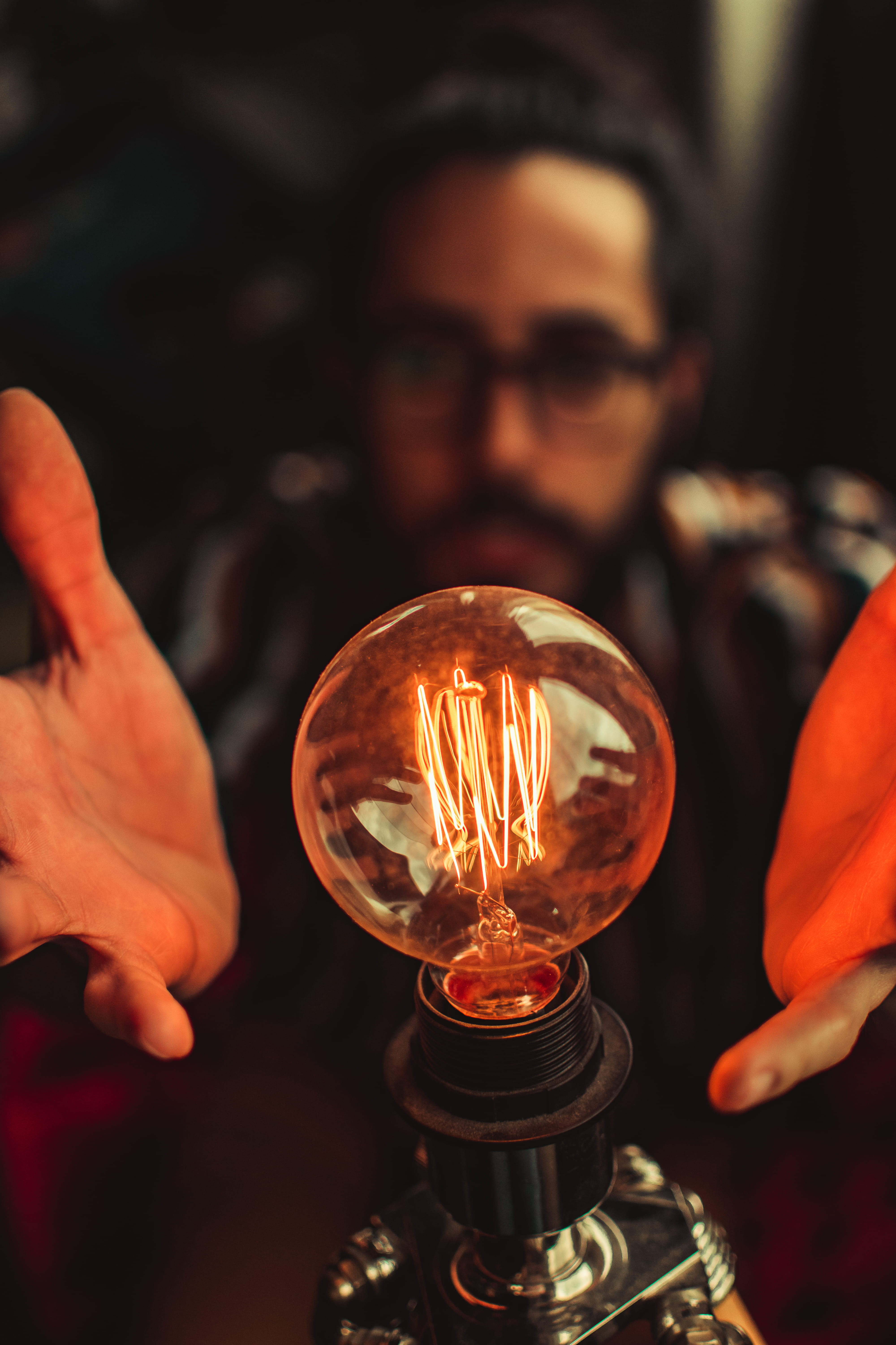 dark, indoors, one person, lifestyles, electric lamp, person, power, plasma, ball, focus, hold, lighting equipment, young men, transparent, filament, concert, Phone HD Wallpaper