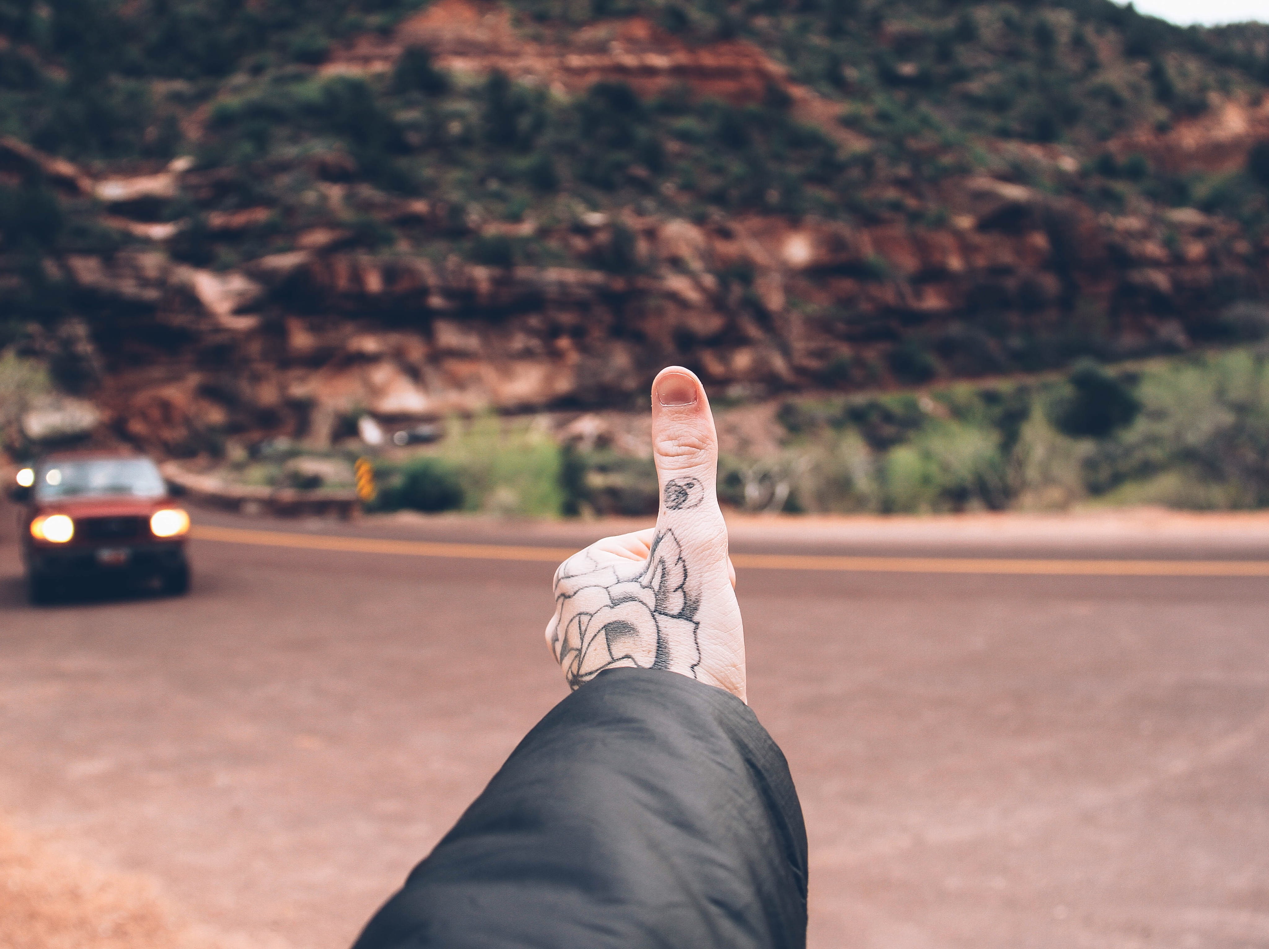 focus on foreground, 4K, jeans, mountain, hand, tree, day, rock, explore, one person, road, human foot, men, low section, unrecognizable person, red, human leg, HD Wallpaper