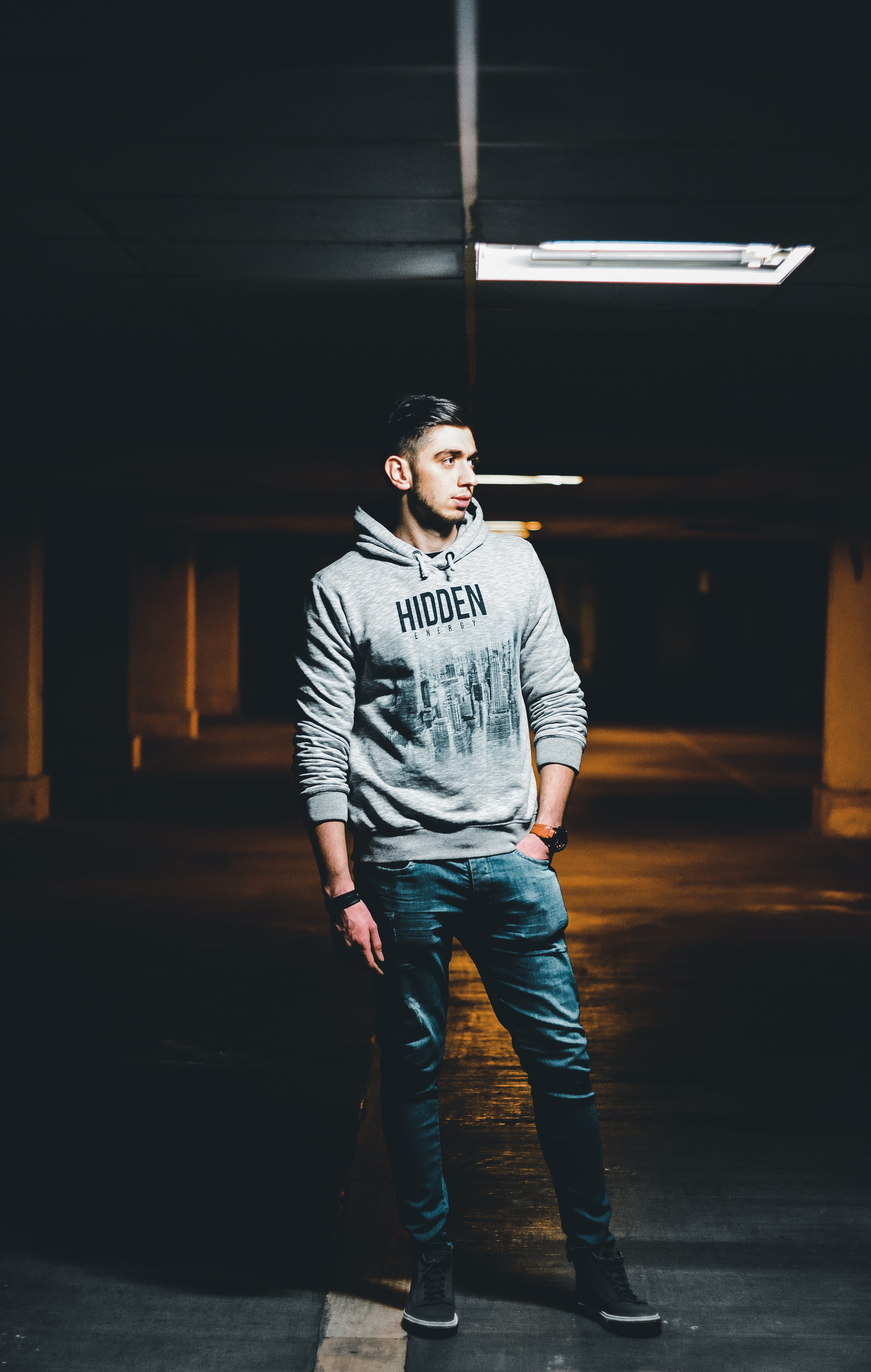 real people, sweater, apparel, looking, contemplation, clothing, indoors, footwear, built structure, text, t-shirt, teenager, column, one person, window, Phone HD Wallpaper