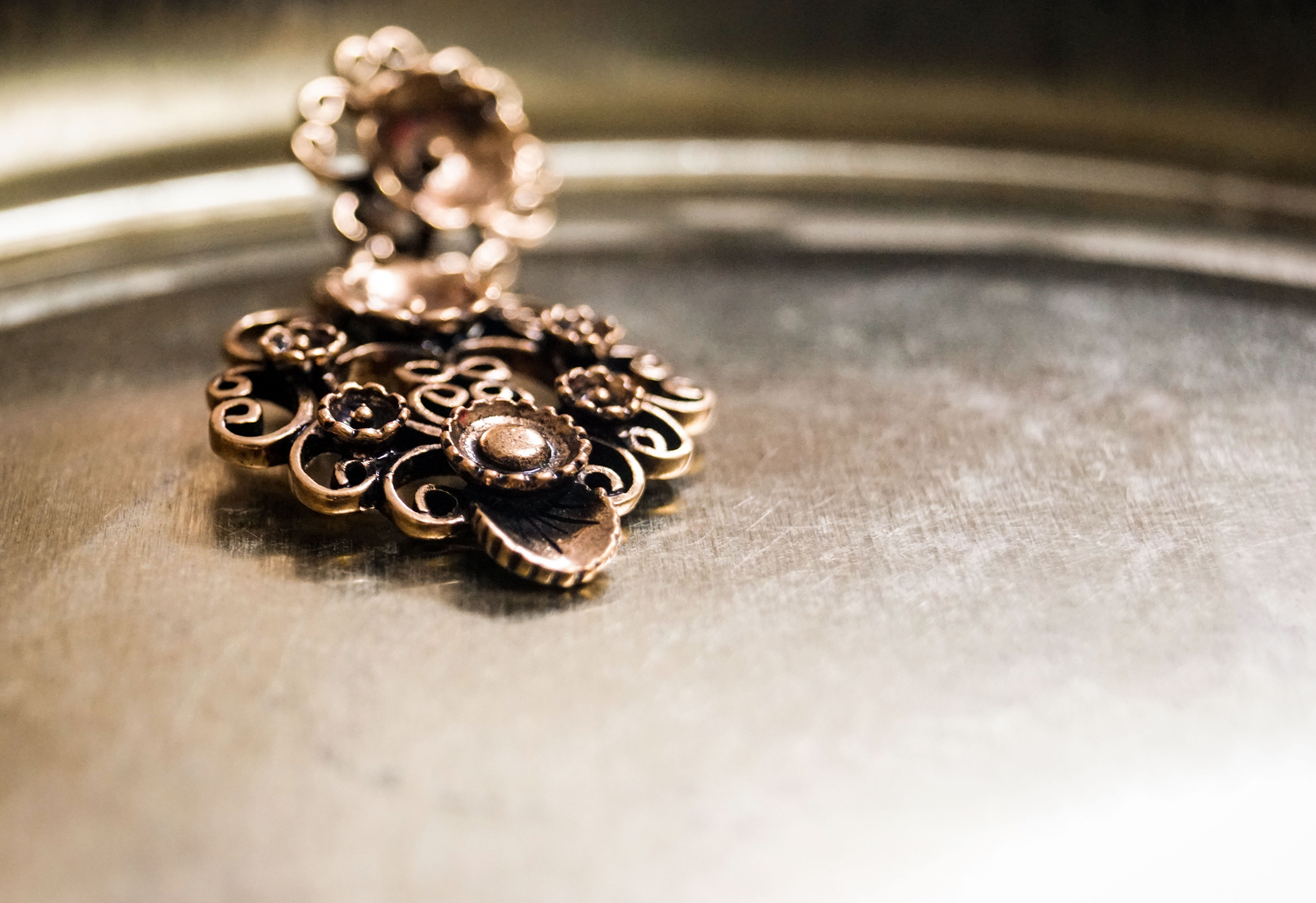 selective focus, patterns, jewelry, ornament, surface, single object, copper, ornate, 5K, personal accessory, floral, close-up, vintage, design, indoors, HD Wallpaper