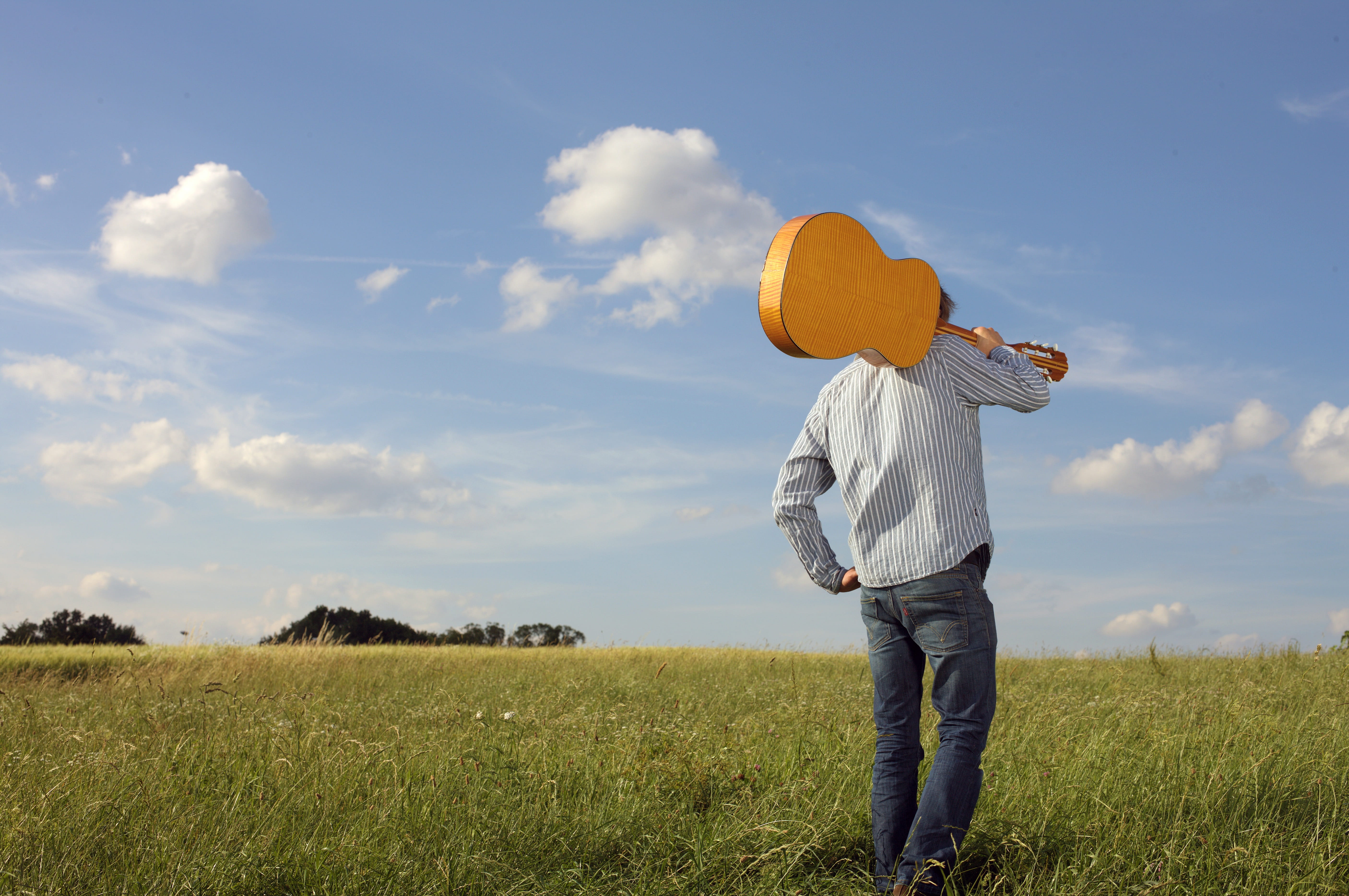 man, guy, carrying, peaceful, land, leisure activity, instrument, grassland, photoshoot, day, obscured face, casual clothing, scenic, long, blue jeans, HD Wallpaper
