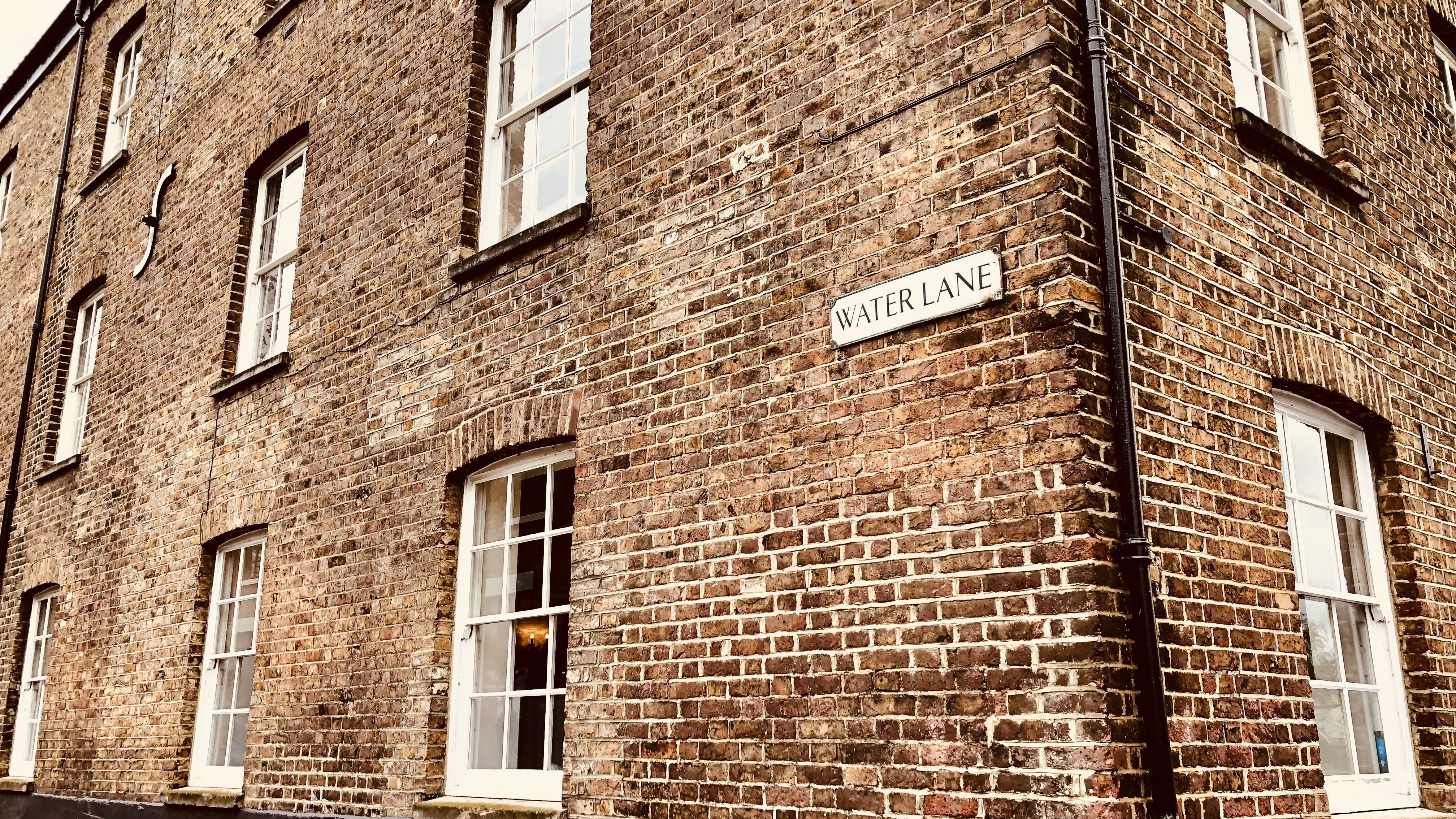 low angle view, sign, no people, architecture, day, western script, wall - building feature, brick wall, building exterior, text, full frame, arrow symbol, HD Wallpaper