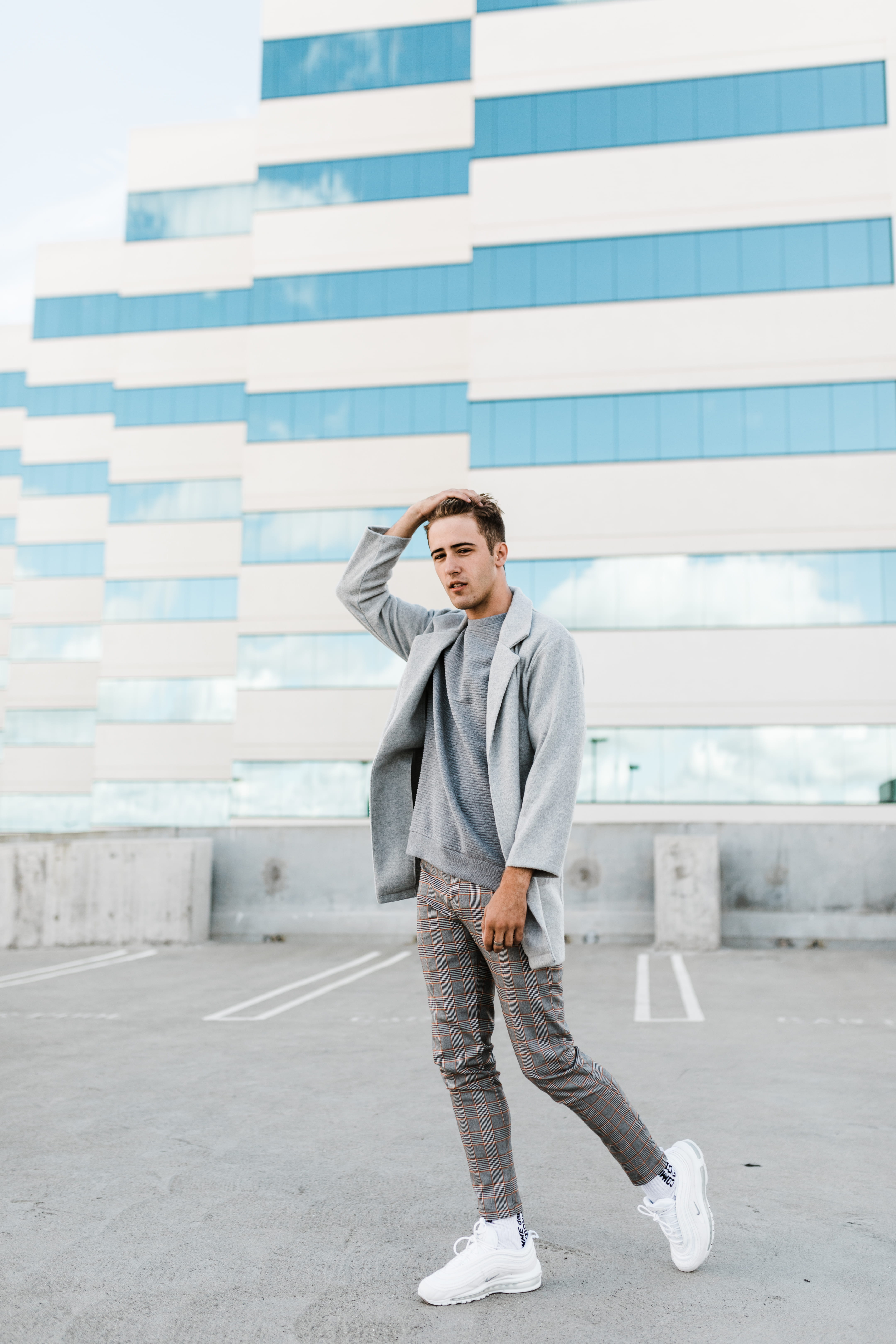 man, street fashion, near, standin, wearing, pants, holding, real people, street portrait, head, building, city, young men, outdoors, human, coat, gray, Phone HD Wallpaper