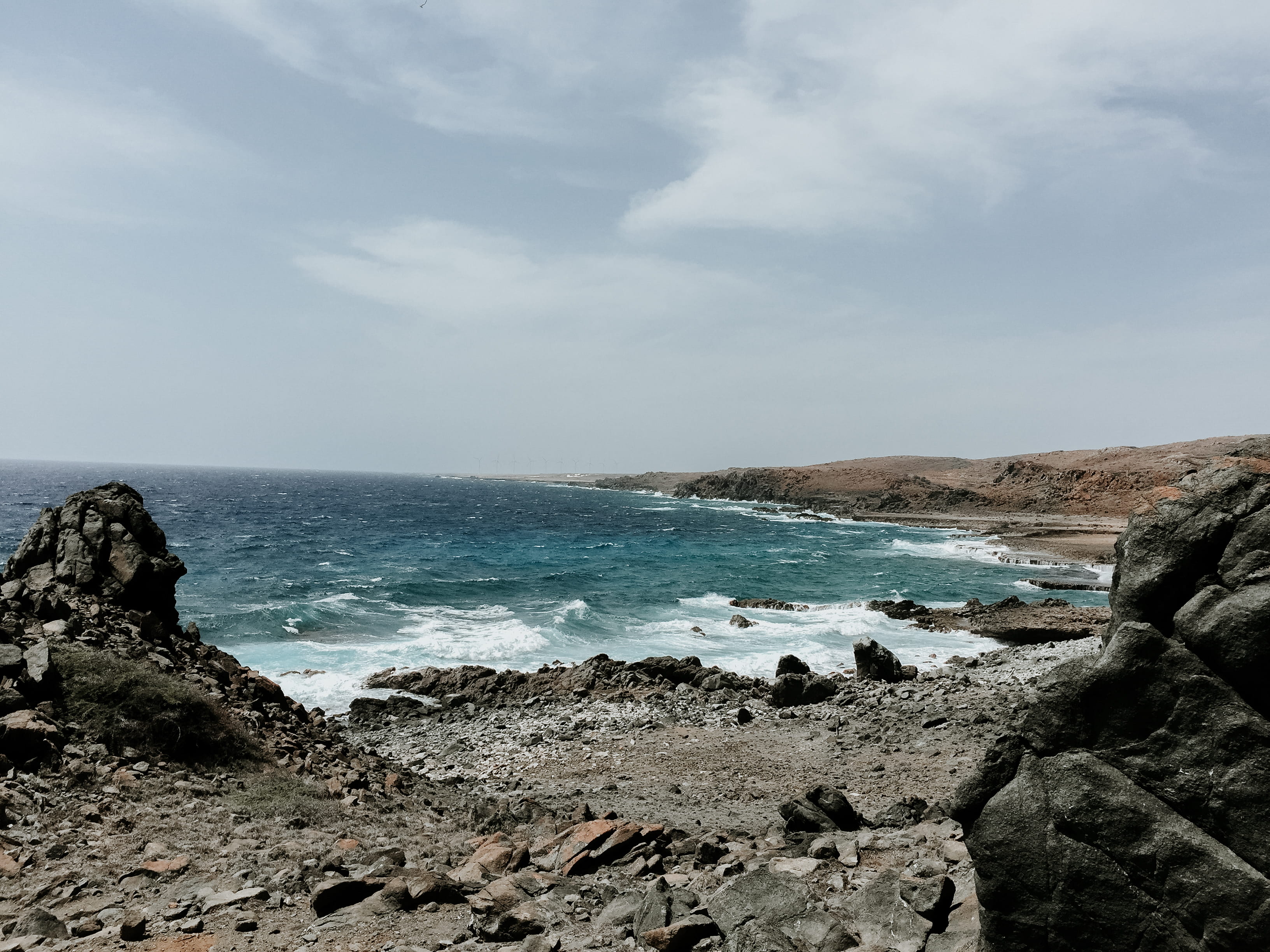 2K, tranquil scene, waves, beach, solid, outdoors, getaway, cloud - sky, horizon over water, no people, ocean, desert, rock - object, aruba, tranquility, HD Wallpaper