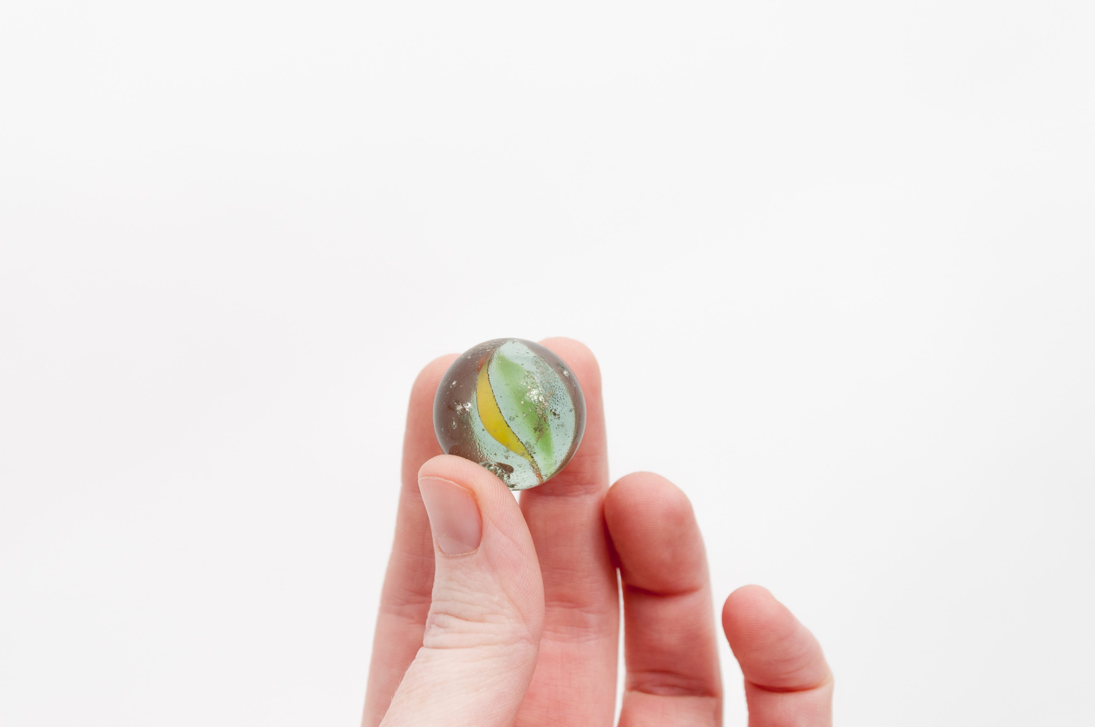 sea life, finger, food, person, contact lens, closeup, human finger, coin, nail, green, marble, holding, yellow, white background, human body part, toy, HD Wallpaper