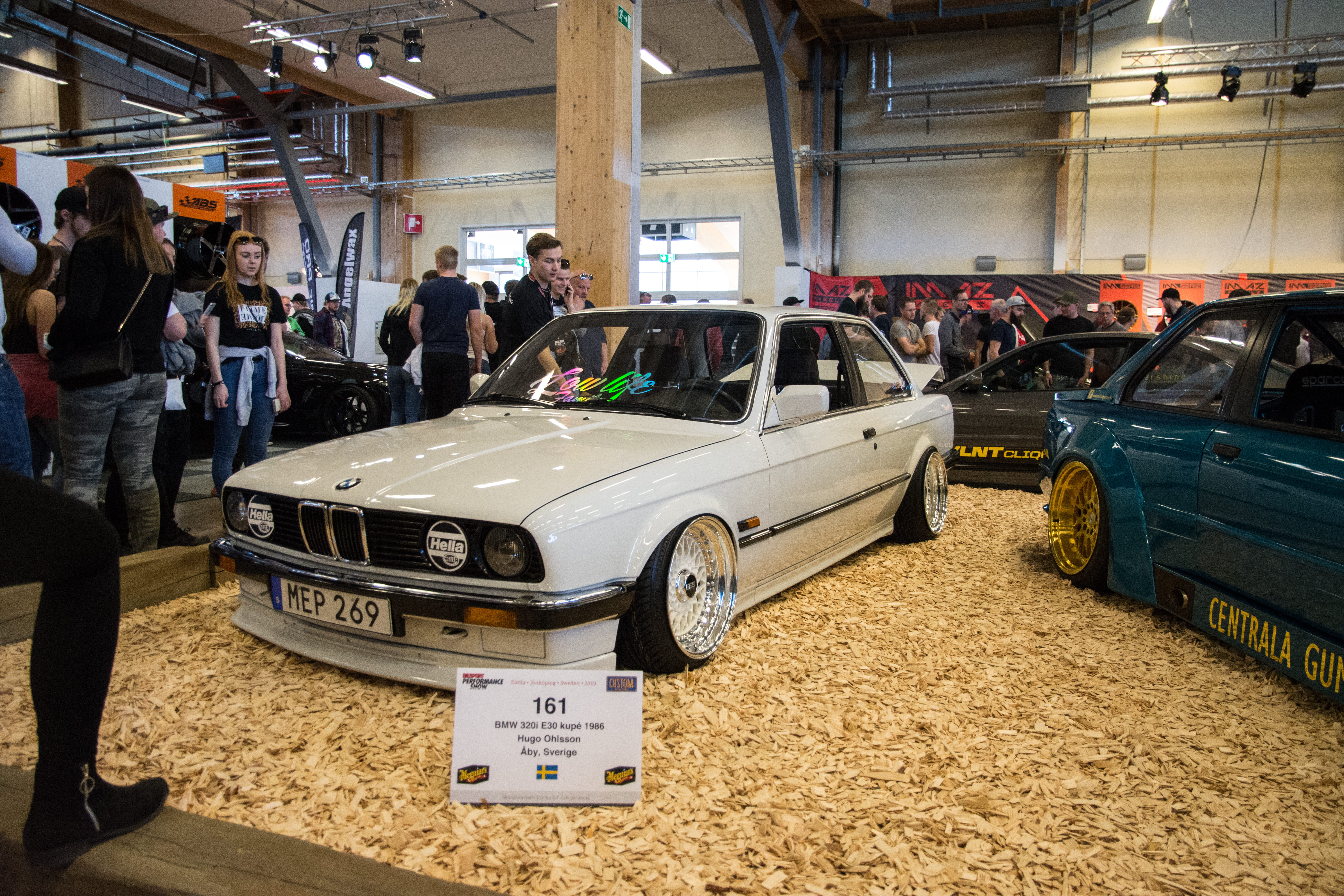 person, text, machine, car show, 5K, car wheel, car, built structure, crowd, indoors, motor vehicle, wood, #bmw, real people, architecture, wheel, incidental people, HD Wallpaper