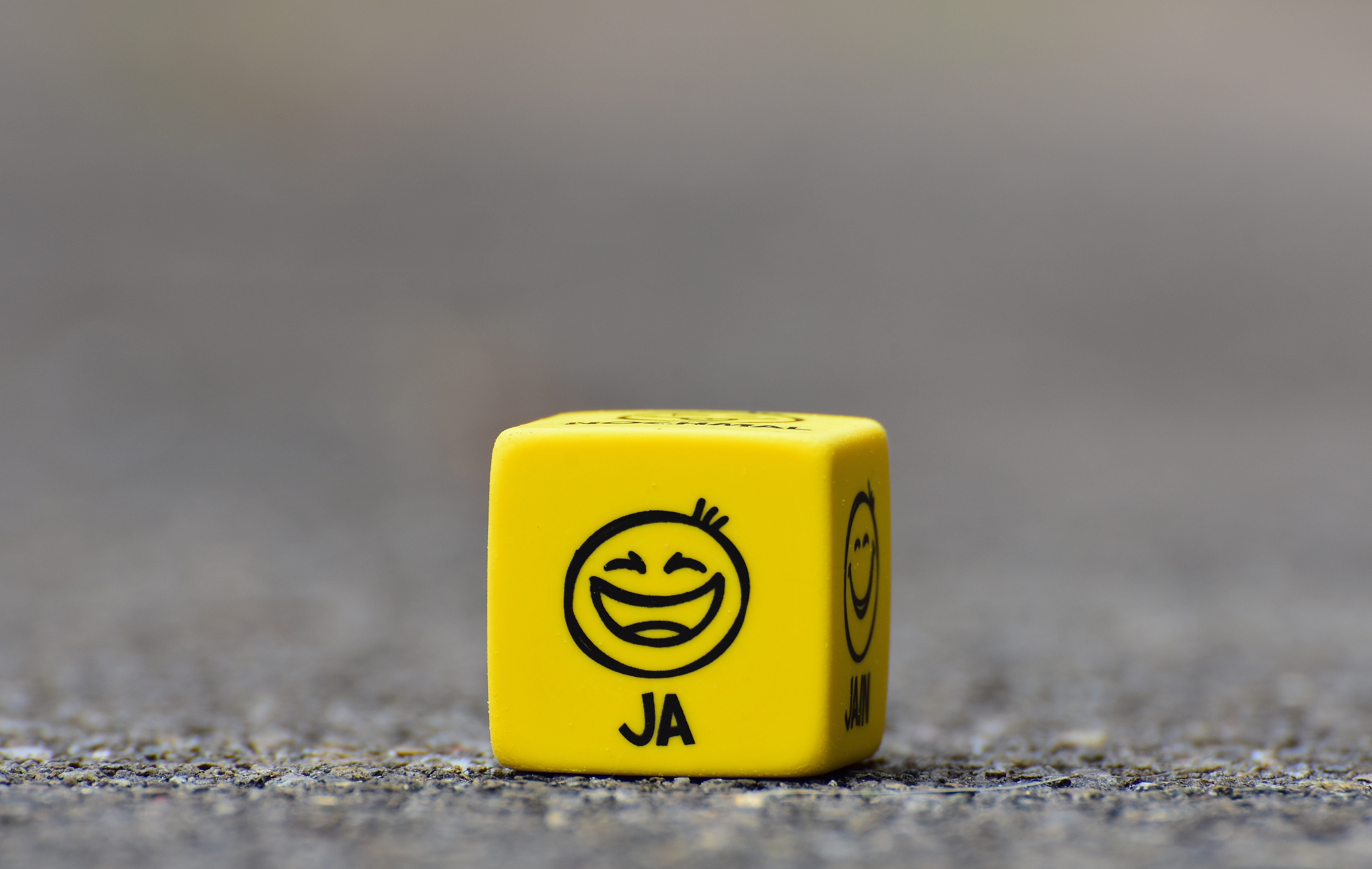 pavement, emotions, 5K, faces, close-up, single object, studio shot, day, blur, no people, cube, text, yellow, smile, funny, toy, fun, metal, game, surface level, HD Wallpaper
