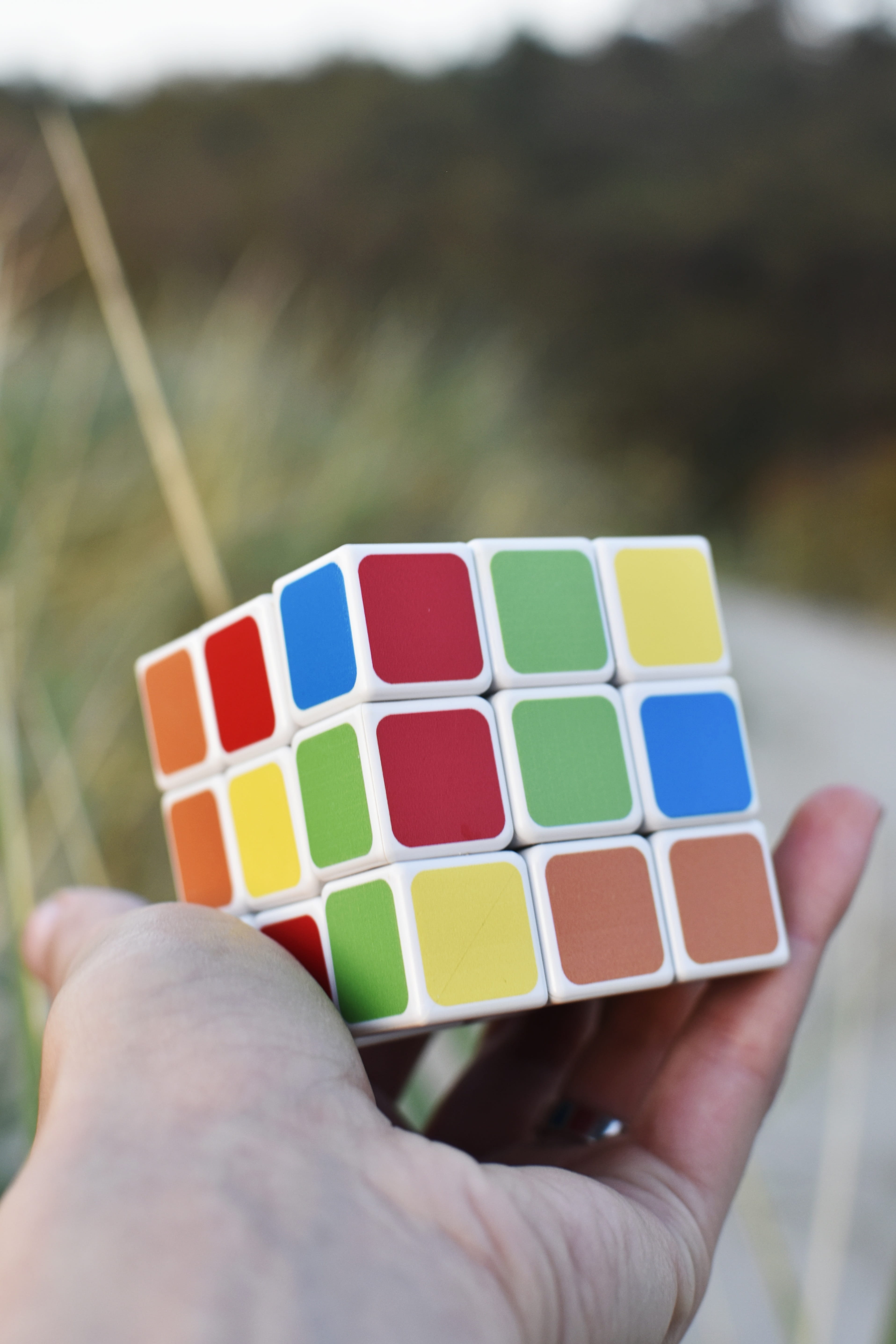 focus on foreground, human hand, winner, human finger, hand, 5K, success, rubiks cube, human body part, unrecognizable person, brain exercise, finger, Phone HD Wallpaper