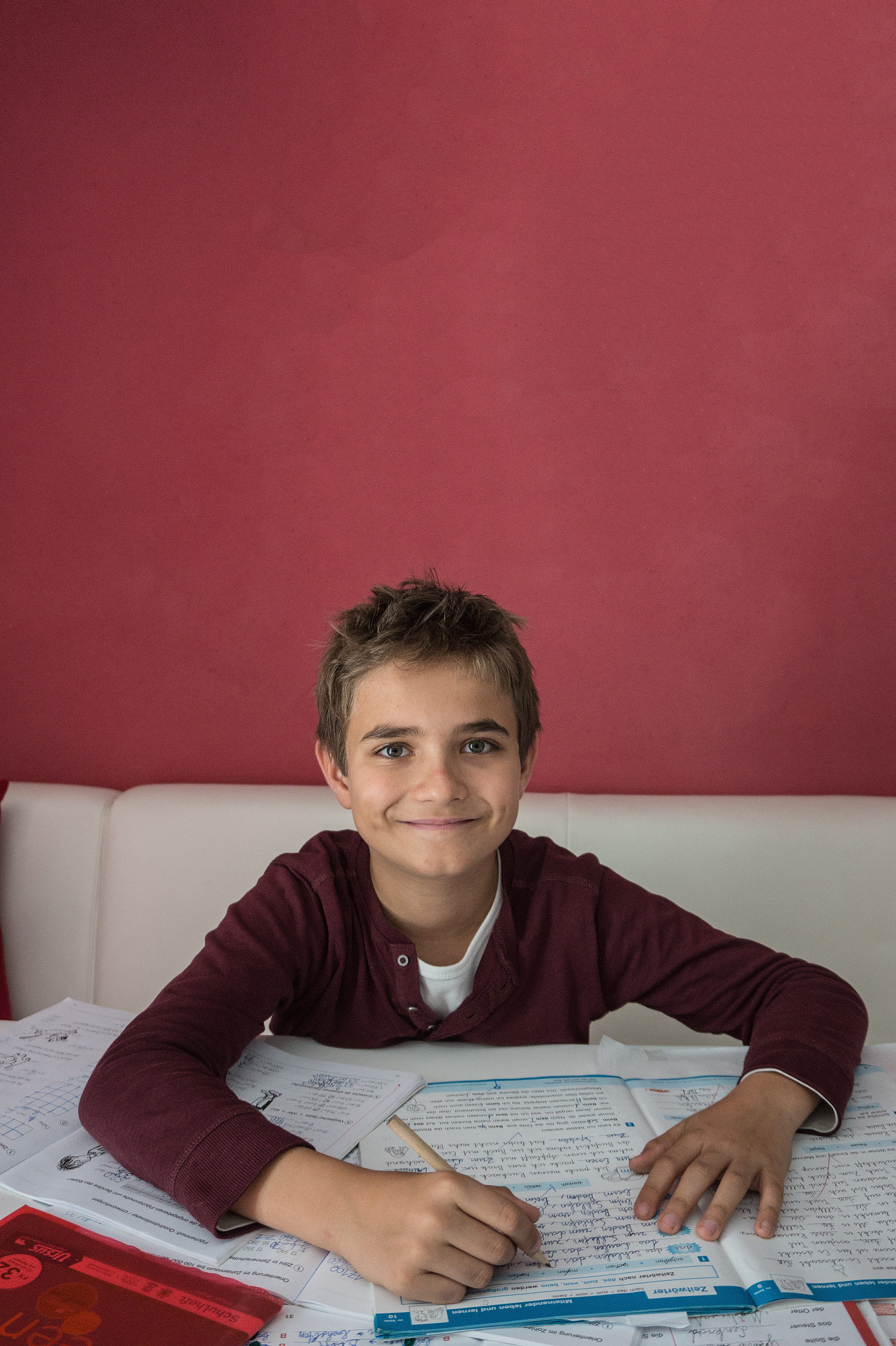 looking at camera, smiling, portrait, pen, Boy, table, casual clothing, indoors, holding, innocence, Learn, copy space, 5K, sofa, furniture, one person, Phone HD Wallpaper