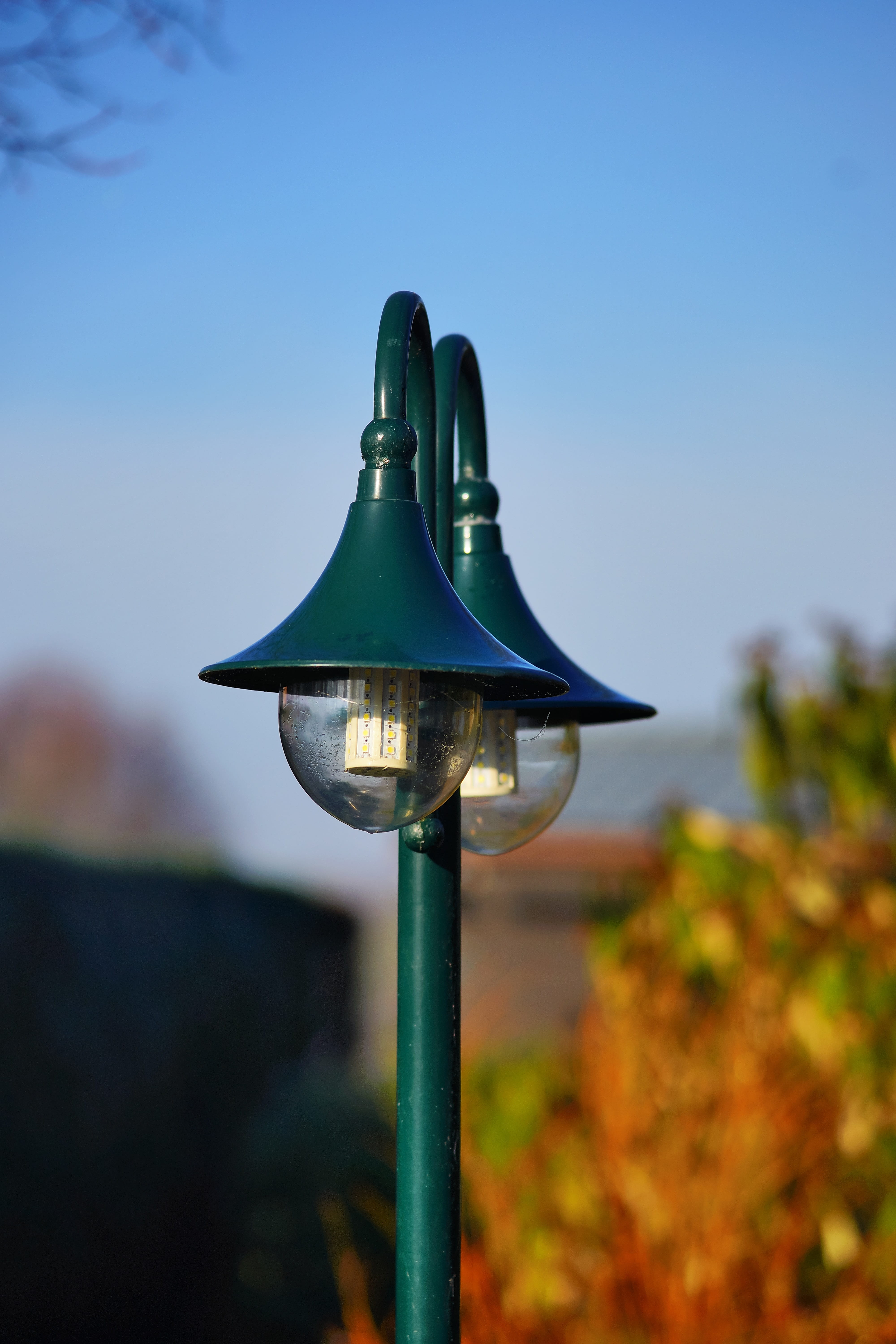 focus on foreground, sunlight, outdoors, shoe, green, ornament, garden, 5K, beauty in nature, lantern, nature, metal, field, growth, no people, electric lamp, Phone HD Wallpaper