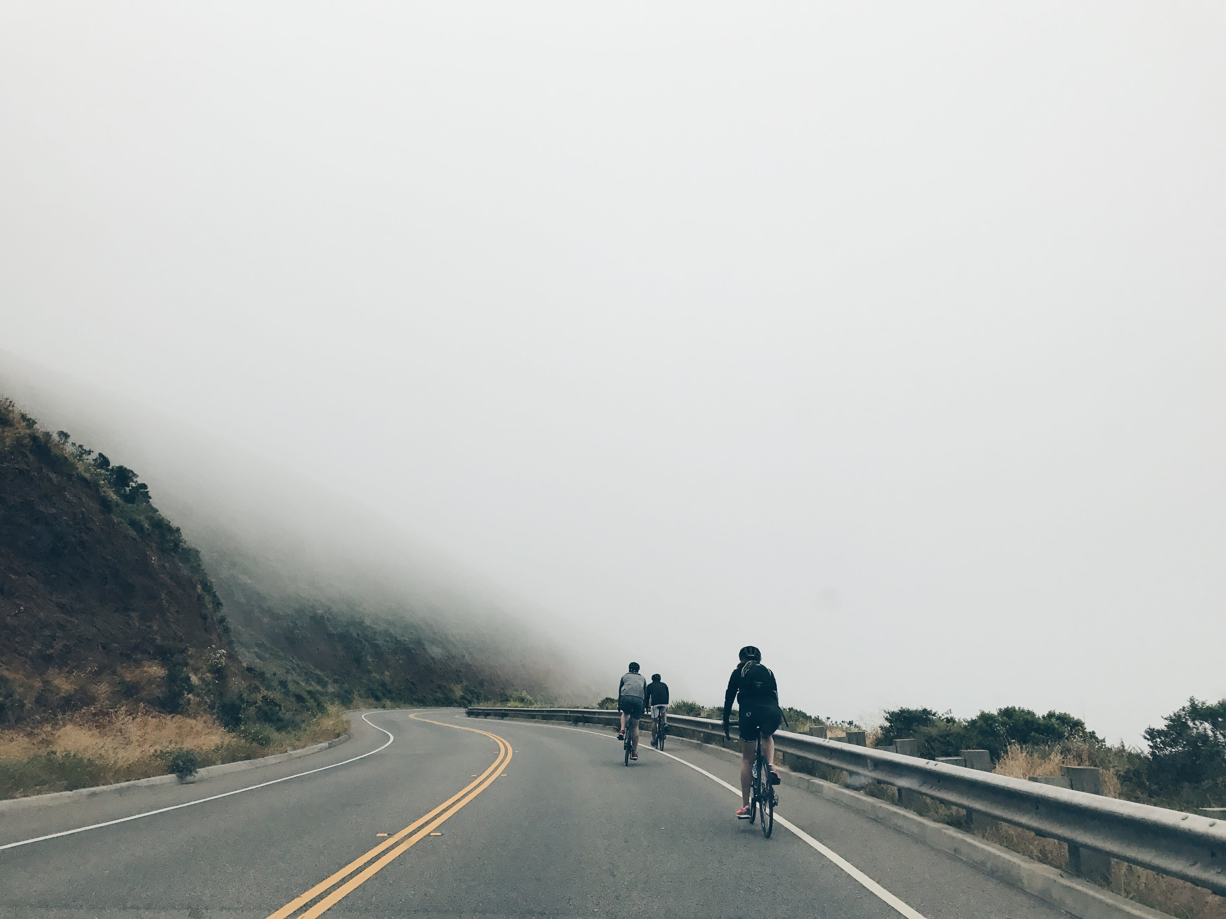 riding, sign, activity, copy space, marking, road, motion, rear view, fog, people, three, mountain, two people, cyclist, transportation, near, men, road marking, HD Wallpaper