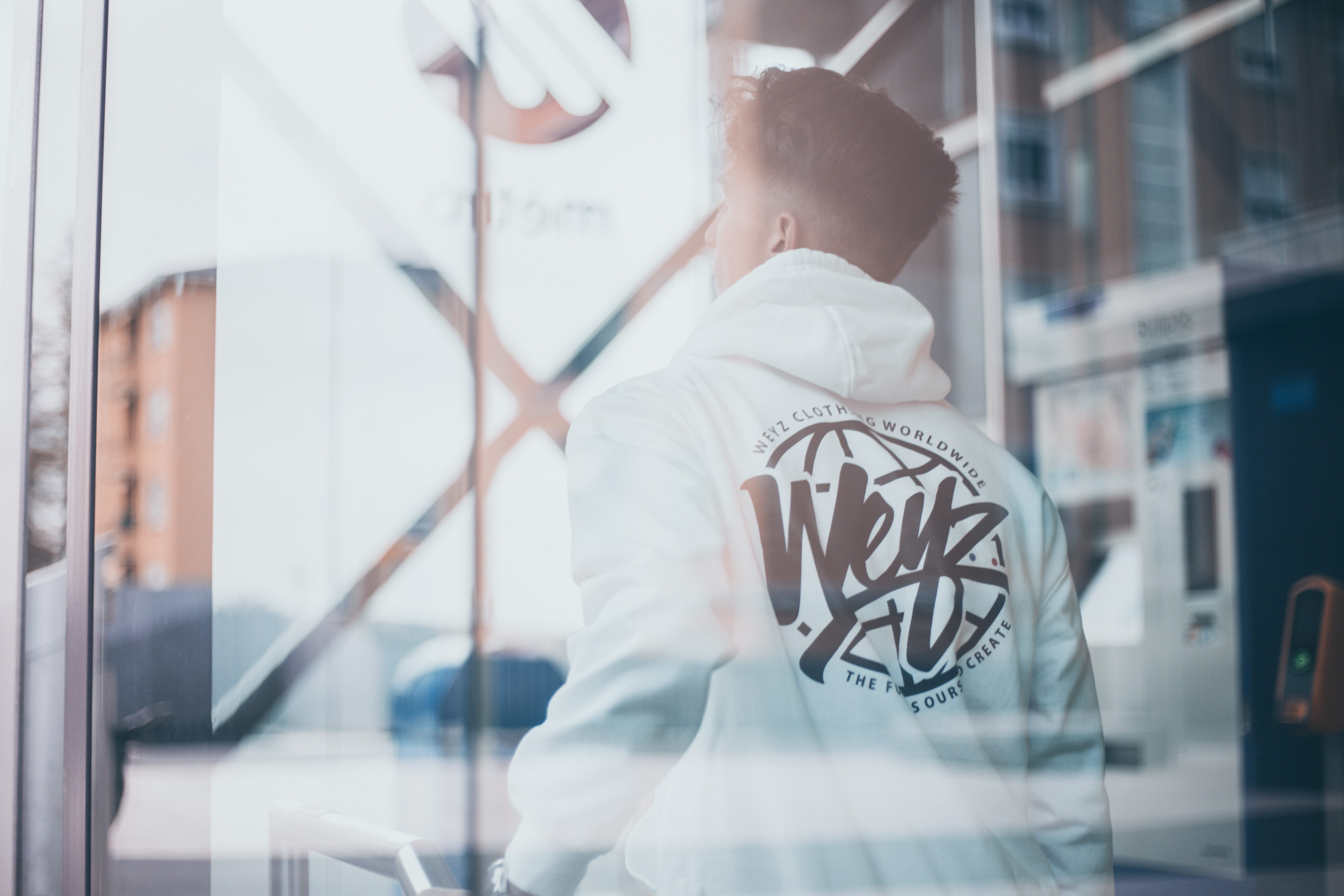 waist up, glass - material, machine, men, day, man, text, window, looking, one person, male, built structure, automated, white, black, hoodie, childhood, HD Wallpaper