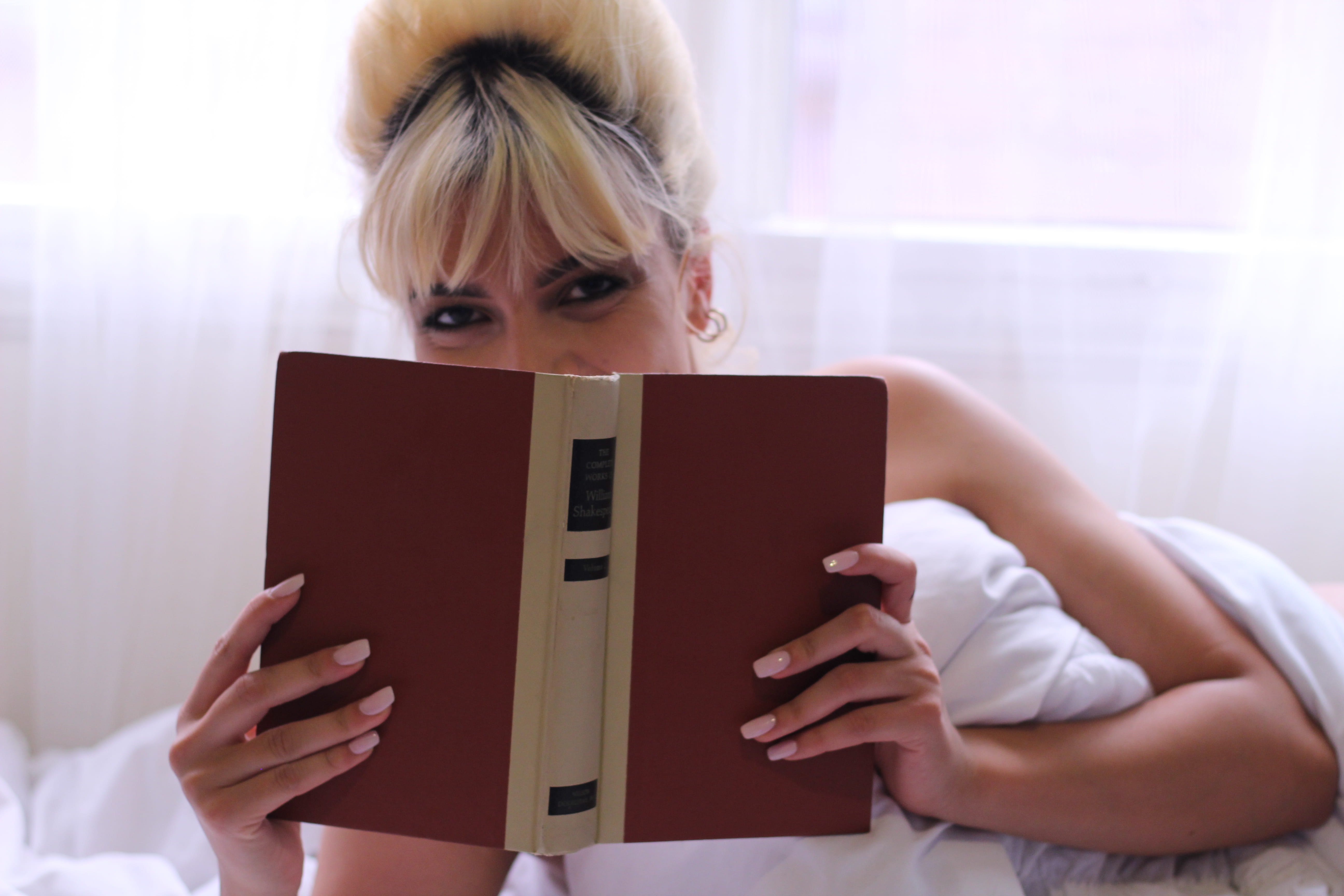 young adult, women, blond hair, eyes, pretty, activity, smiling, photoshoot, 5K, reading, covering, sit, adult, brown, holding, book, book bindings, indoors, HD Wallpaper