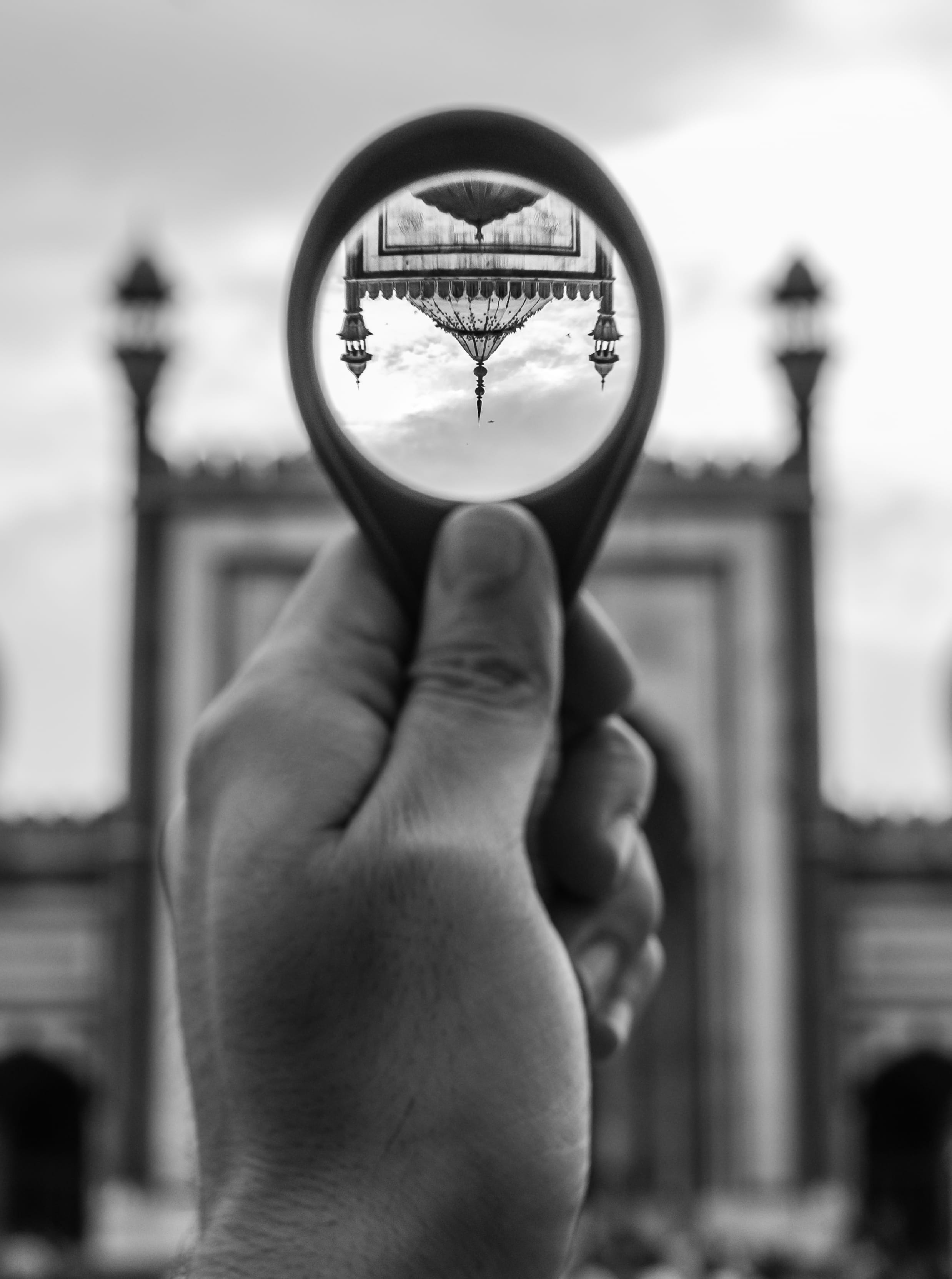 round, 2K, monochrome, outdoors, black-and-white, clock, grayscale, person, built structure, body part, human hand, personal perspective, blur, real people, Phone HD Wallpaper