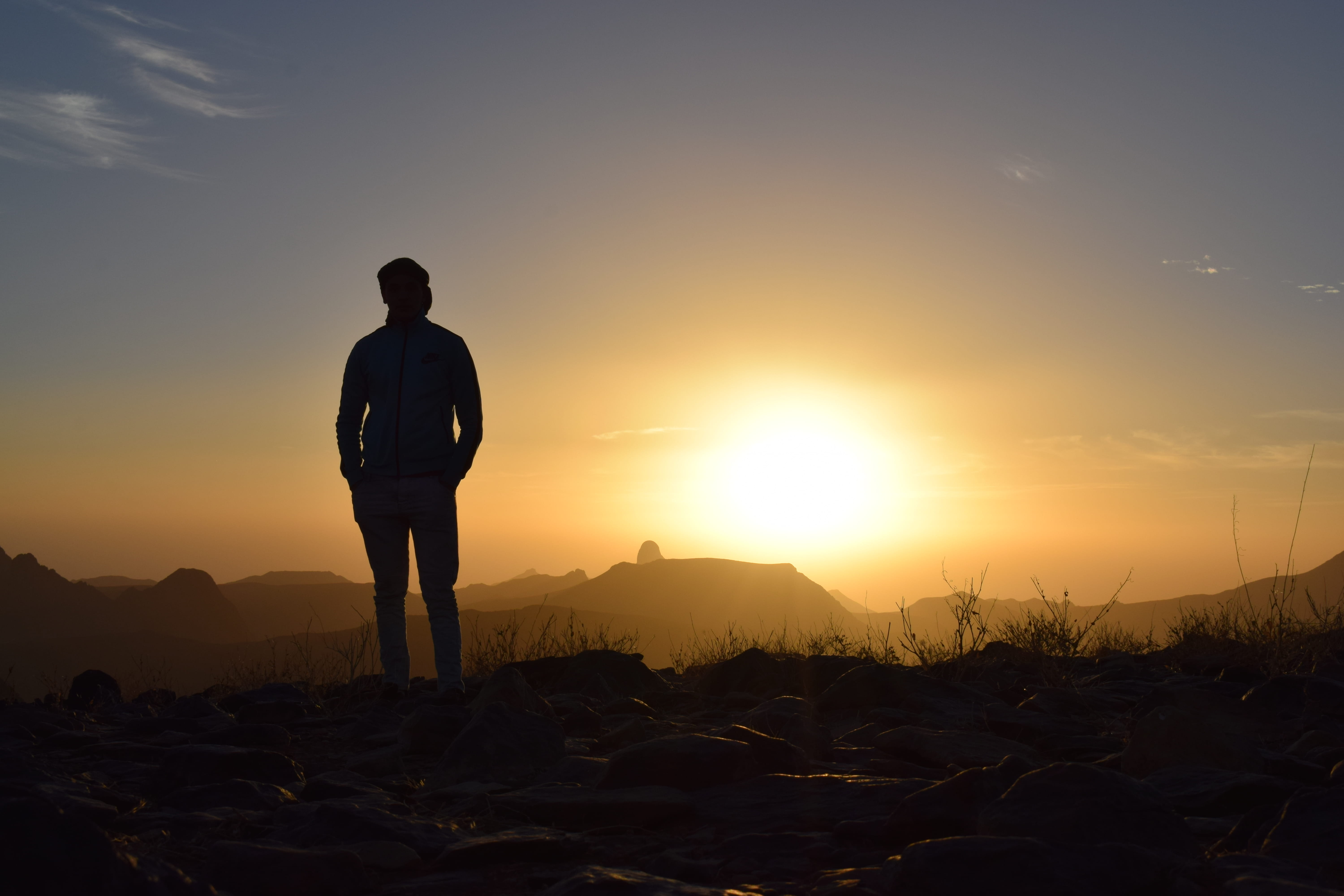 sky, mountain, real people, backlit, man, 5K, travel, evening, taking, grass, landscape, tranquility, orange color, rear view, silhouette, standing, person, HD Wallpaper
