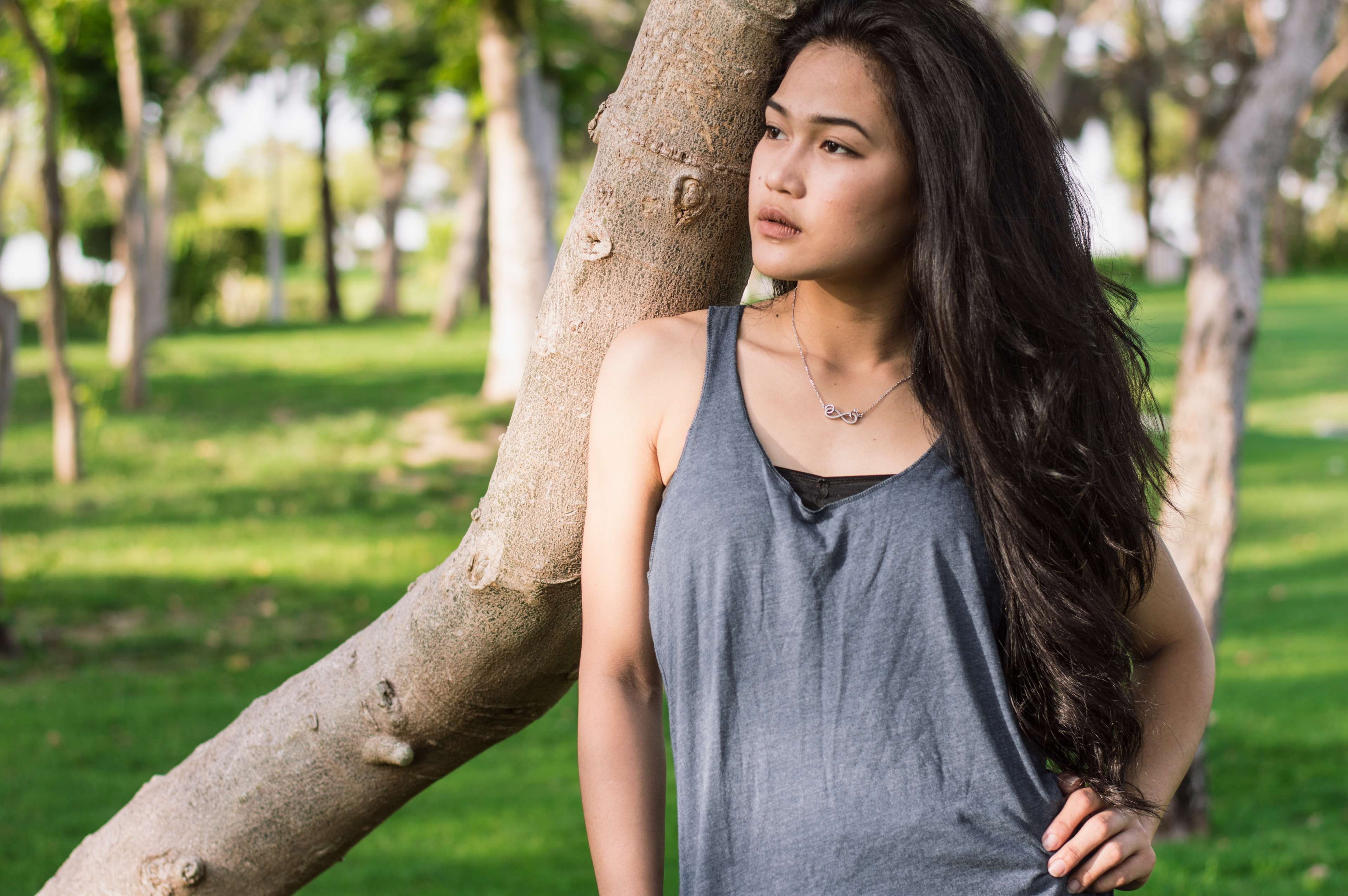 hairstyle, waist up, front view, tops, focus on foreground, day, plant, contemplation, tree trunk, long hair, young adult, crossfit, outdoors, park - man made space, HD Wallpaper