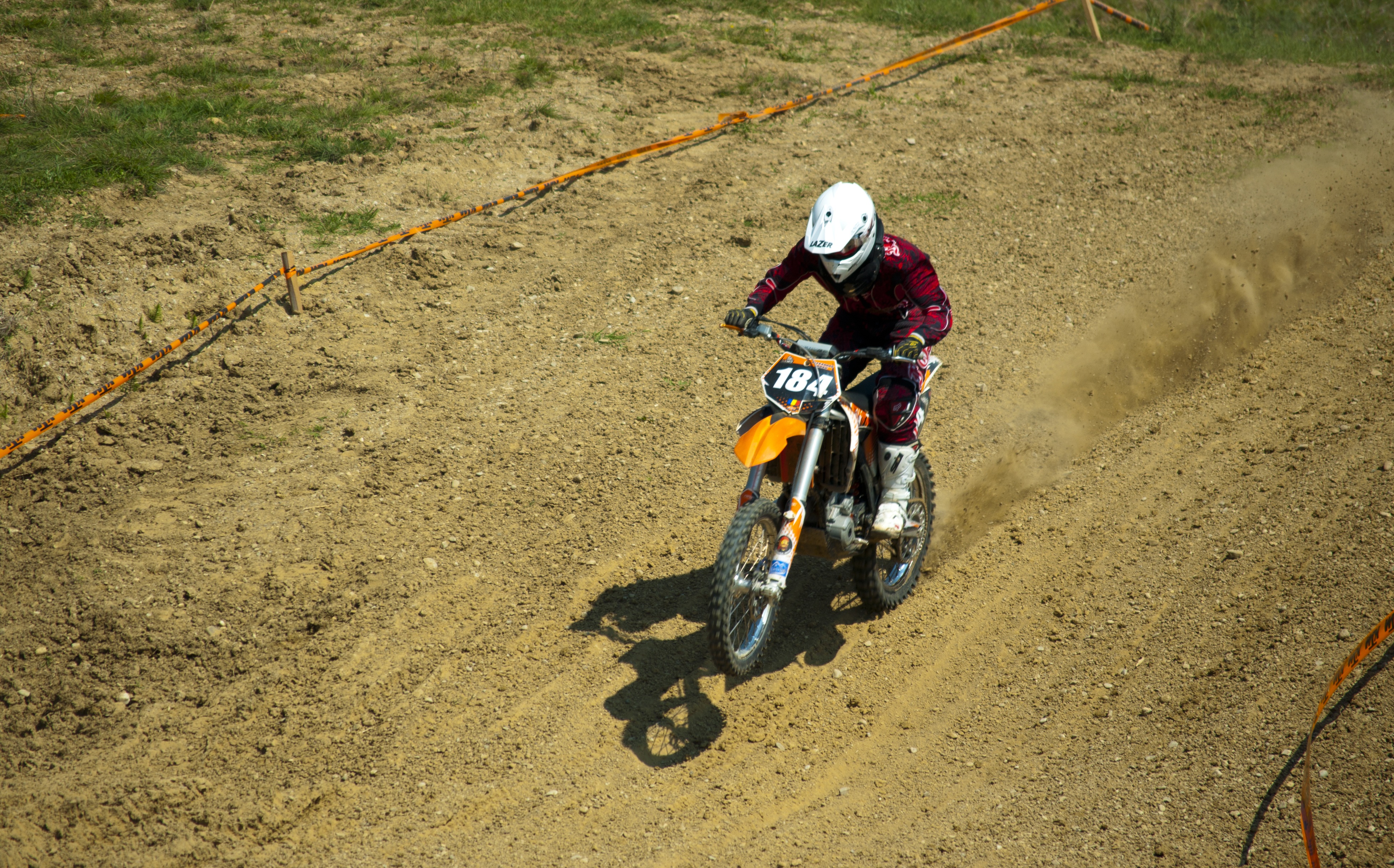 one person, rider, cycle, real people, race, symbol, sport, dirt, motorbike, sunlight, bike, vehicle, high angle view, headwear, action, extreme, day, sign, HD Wallpaper