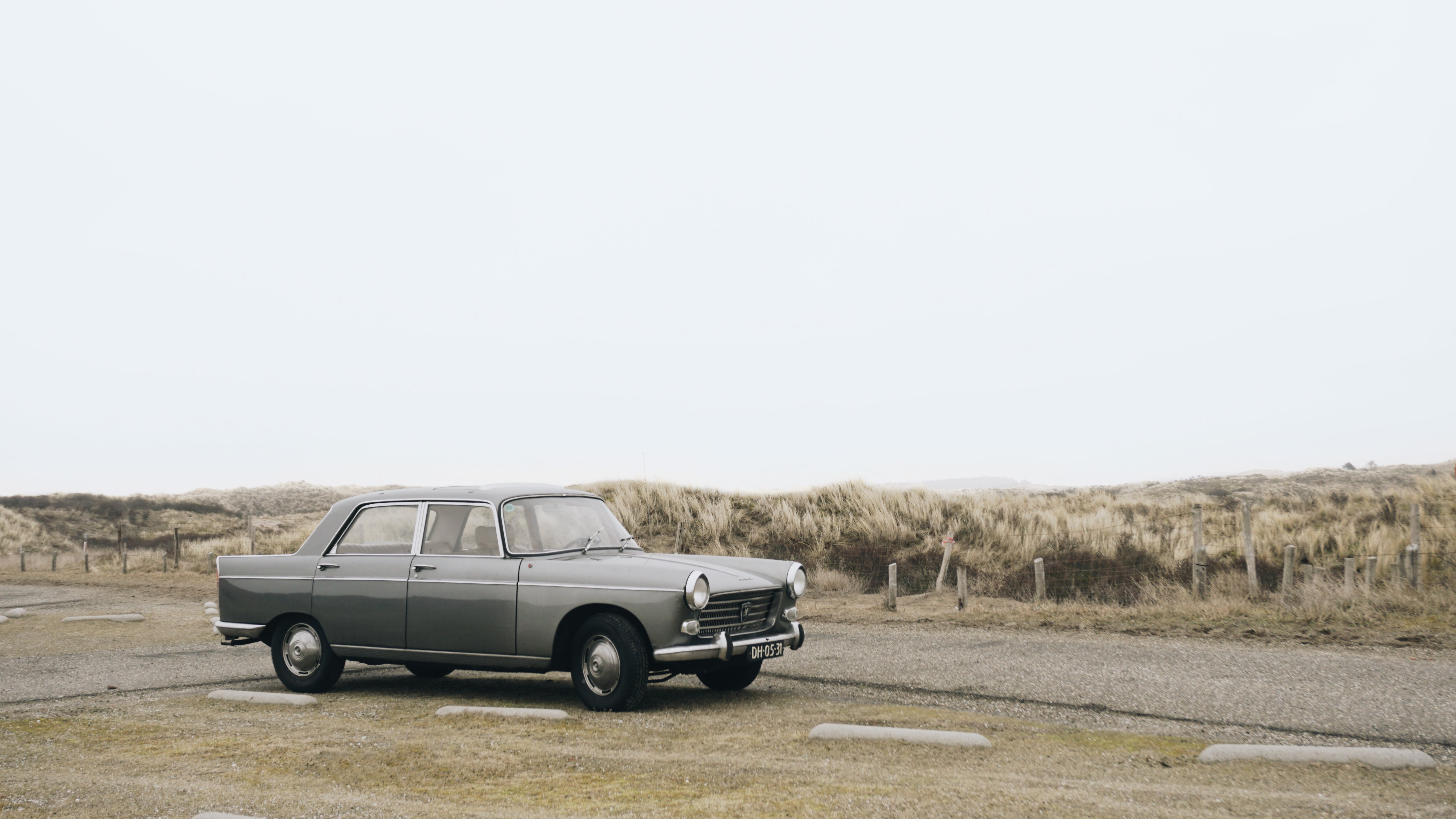 motor vehicle, road, non-urban scene, near, ahead, daytime, sky, beach, james bond, remote, transportation, old school, land, car, freedom, sedan, copy space, HD Wallpaper