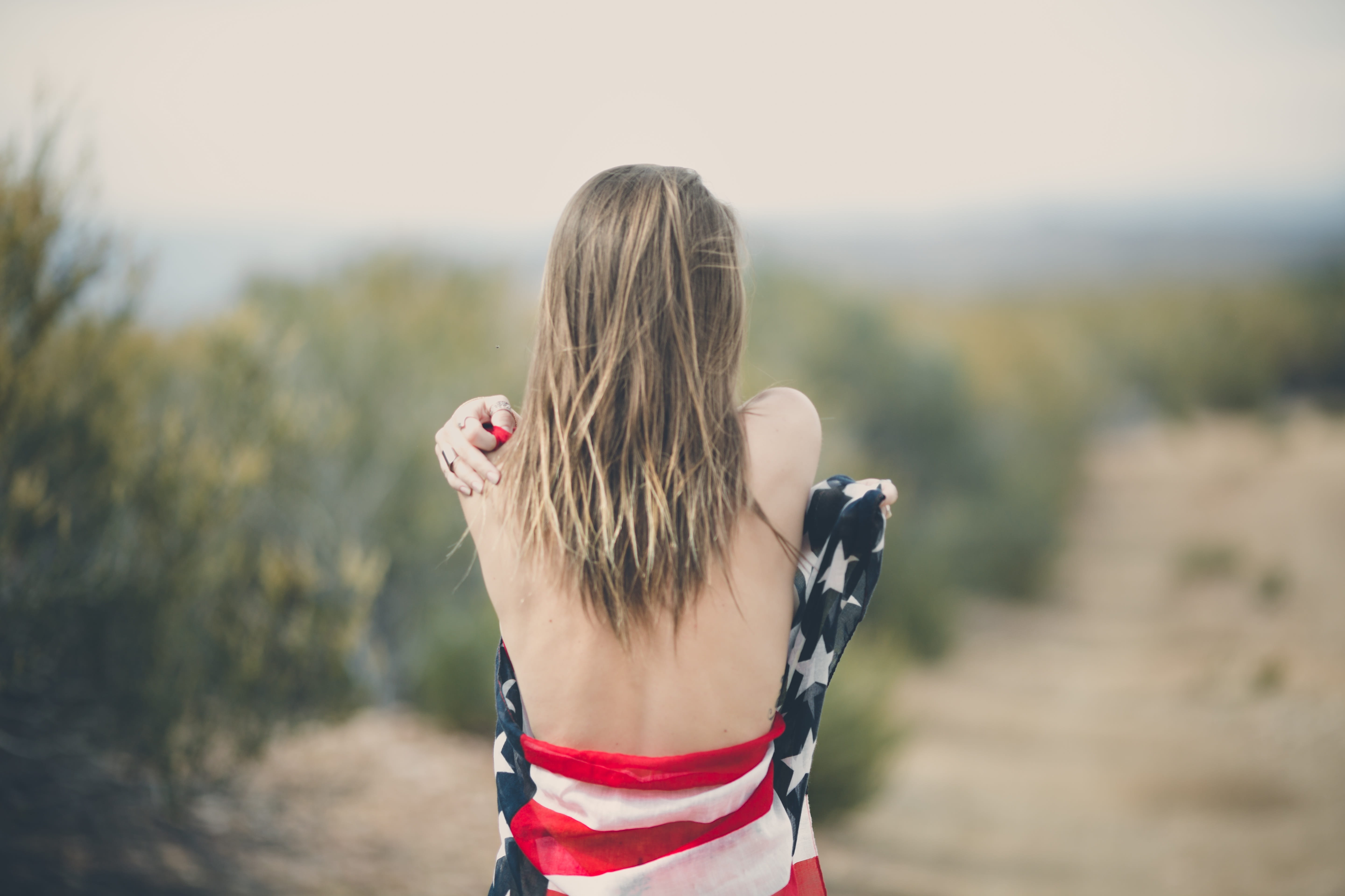 back, focus on foreground, waist up, outdoors, flag, real people, casual clothing, blond hair, outdoor, hair, nature, day, hairstyle, one person, girl, HD Wallpaper