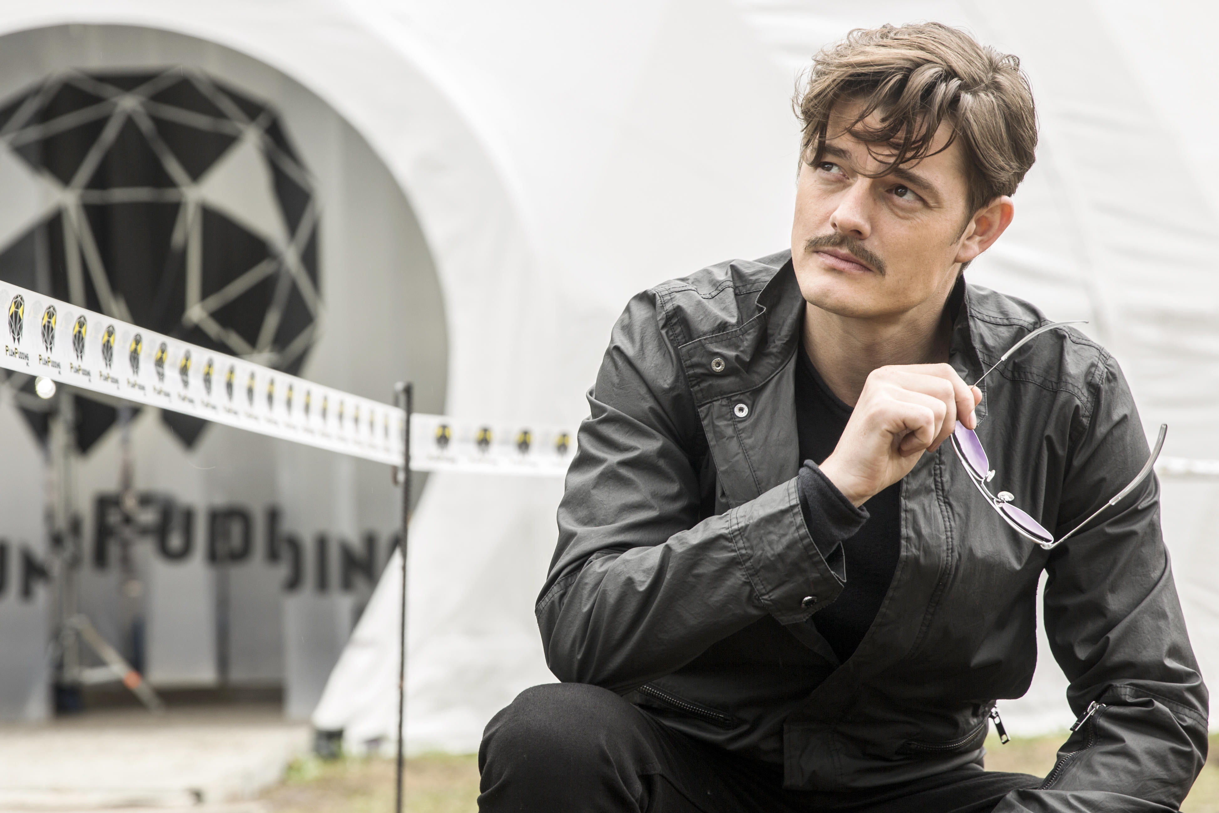 people, focus on foreground, jacket, front view, clothing, one Person, day, serious, sitting, actor, sam riley, technology, males, architecture, black, HD Wallpaper