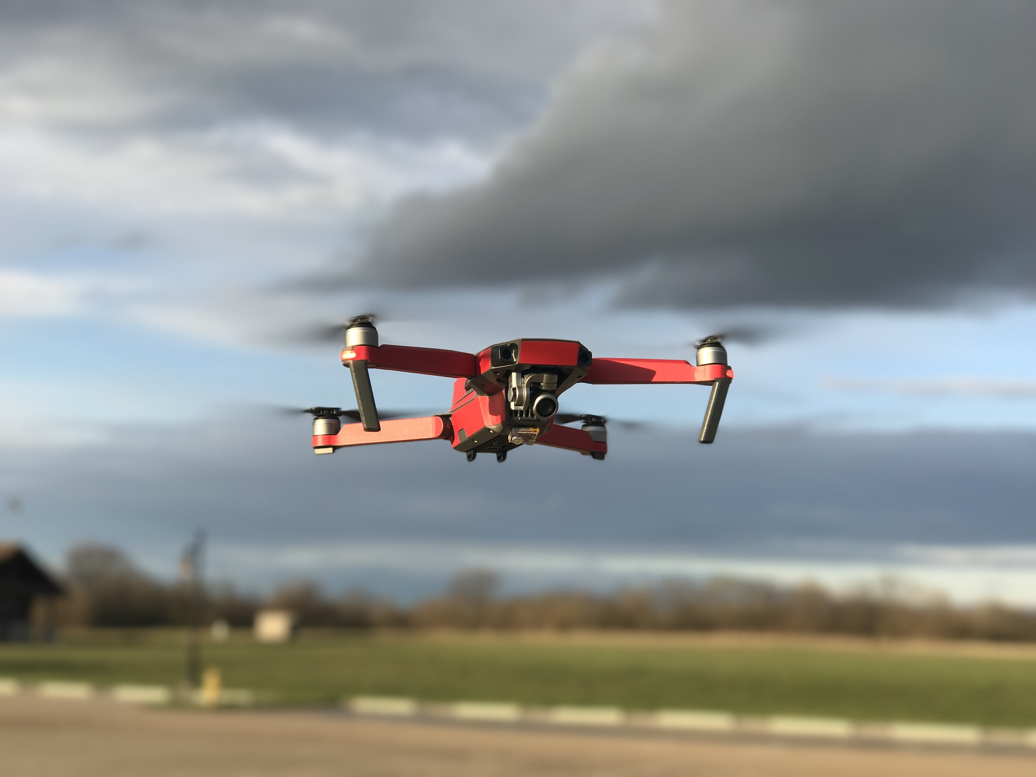 land, landscape, aircraft, outdoors, field, motion, aviate, mode of transportation, cloud - sky, dark clouds, camera, flying, technology, no people, air, HD Wallpaper